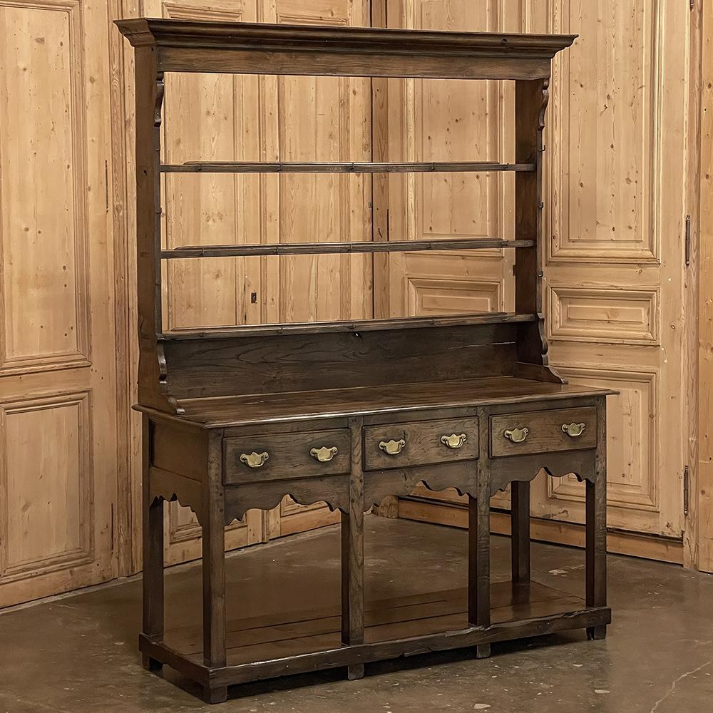 18th Century English sideboard with plate rack will make a charming addition to any room! The light and airy effect is a result of the open plate rack above, and the raised casework below which houses only three drawers. A fine multi-tiered crown