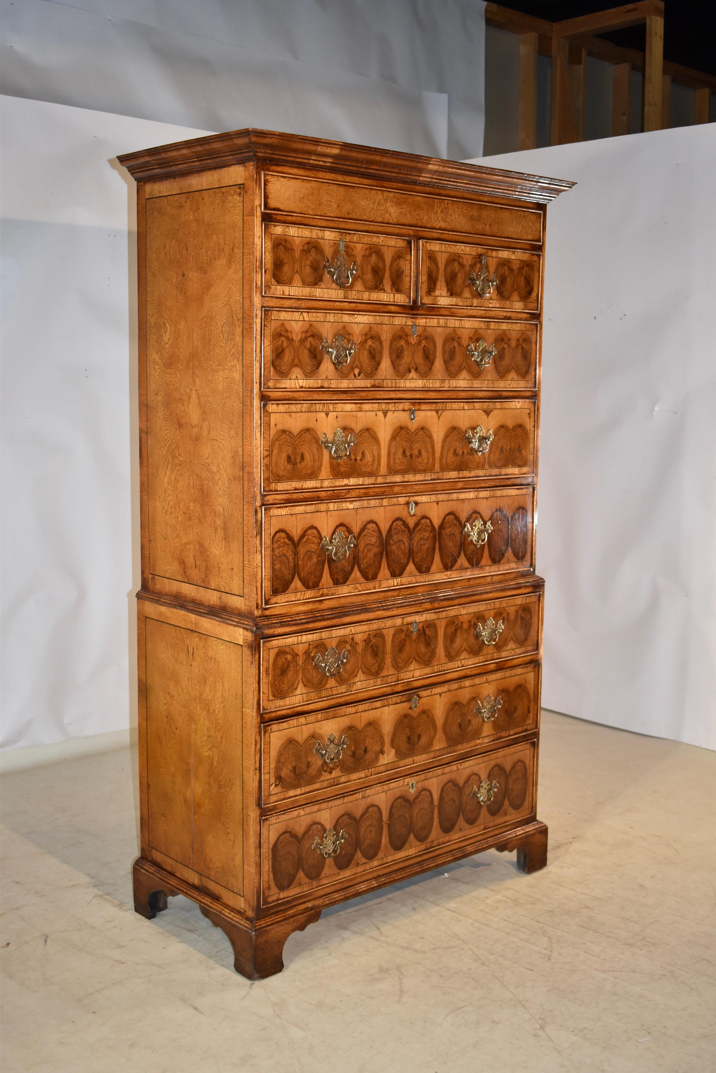 Fabulous and RARE! 18th century oak tall chest of drawers with wonderful oyster walnut veneer on the drawer fronts. The top of the case has a gorgeous crown, following down to sides which have been paneled in book matched oak veneer with the most