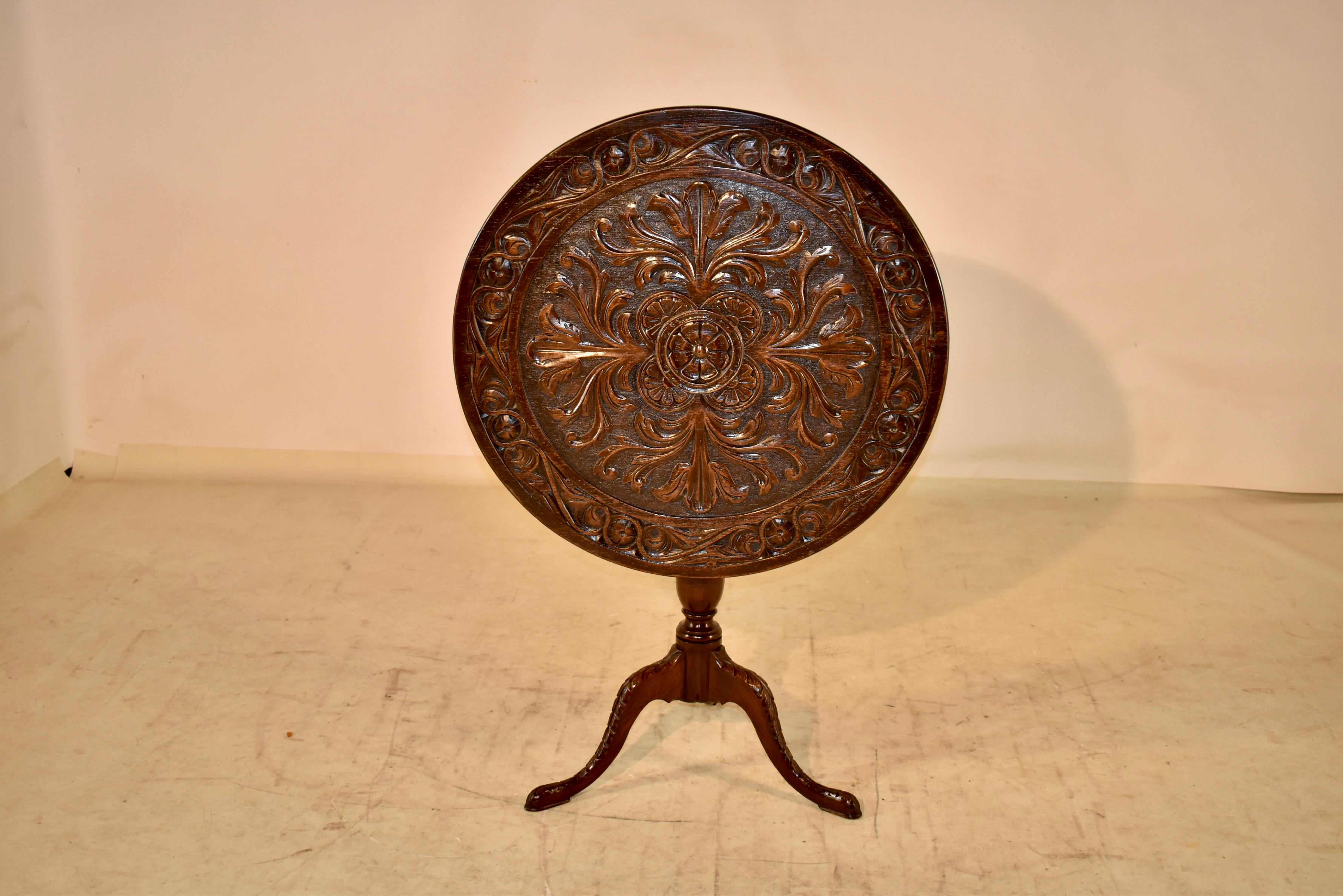 18th century oak tilt-top side table from England with an exquisitely hand carved decorated top. The top is banded and is in a scrolled pattern, surrounding the central medallion, which has a rosette in the center, surrounded by scrolling acanthus