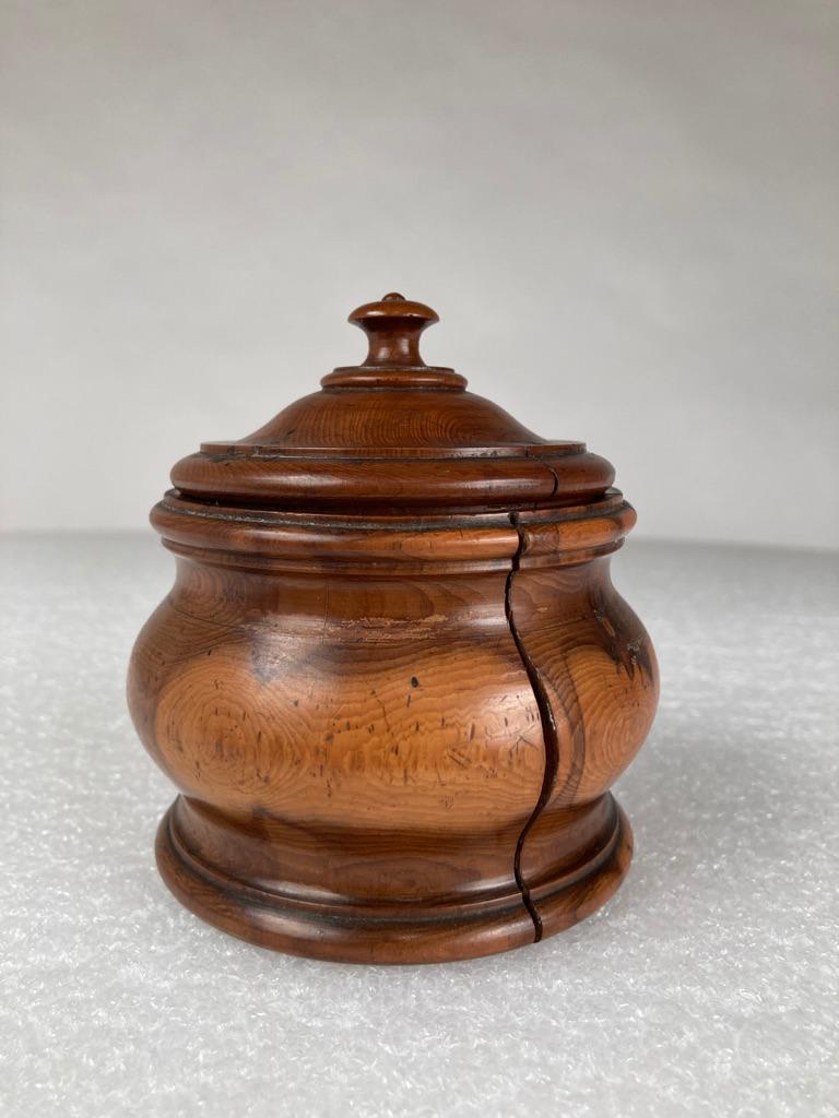 Lovely 18th century Georgian lidded jar or condiment pot hand carved and turned from a beautiful piece of yew wood. Rich and warm patina from age and use. From a New York City private collection. 
Measures: 4 inches high 3.75 diameter.