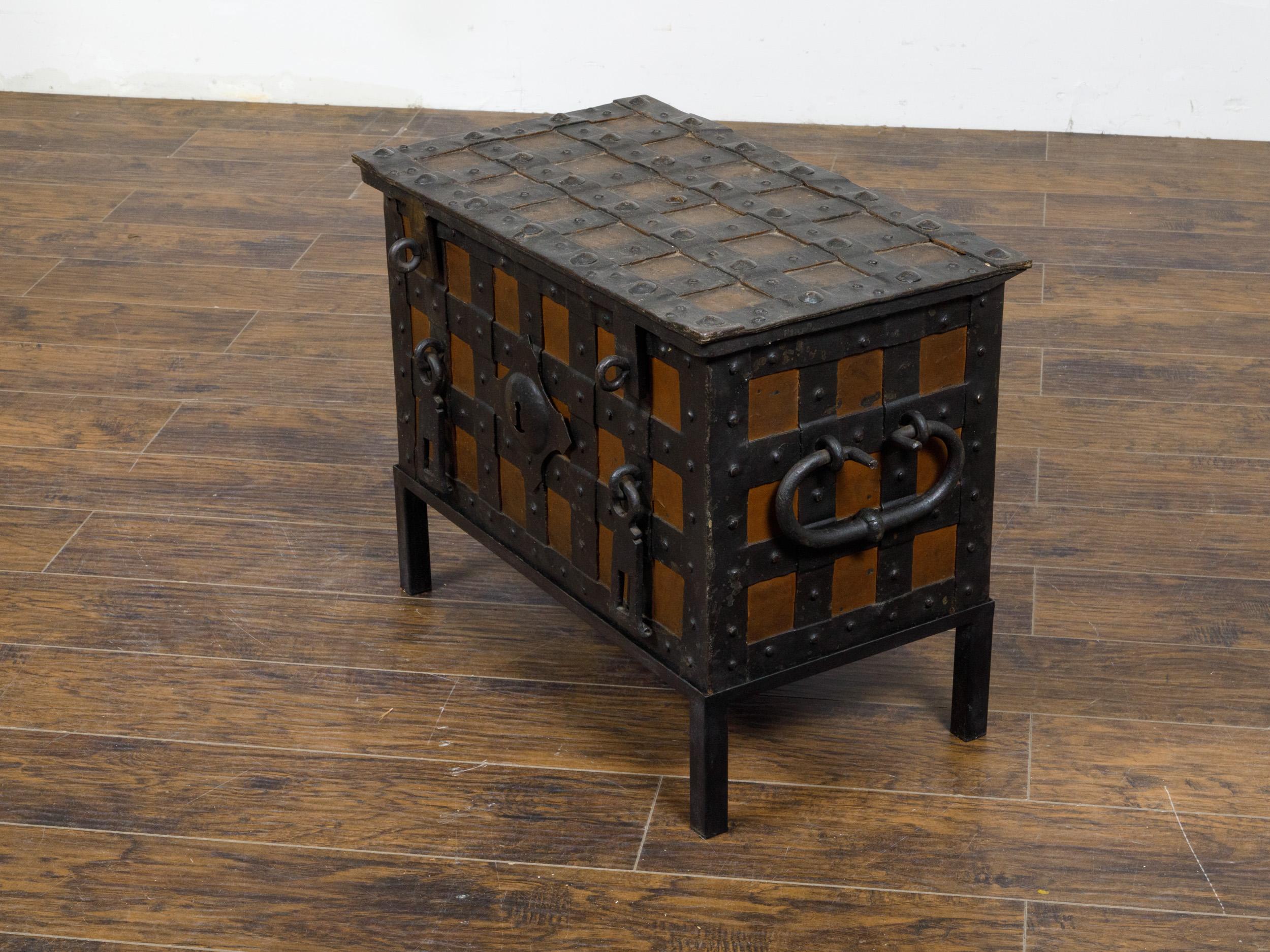 An English two-toned wrought iron and wood sea chest from the 18th century mounted on custom metal base. This captivating English two-toned wrought iron and wood sea chest from the 18th century showcases both robust craftsmanship and elegant design.
