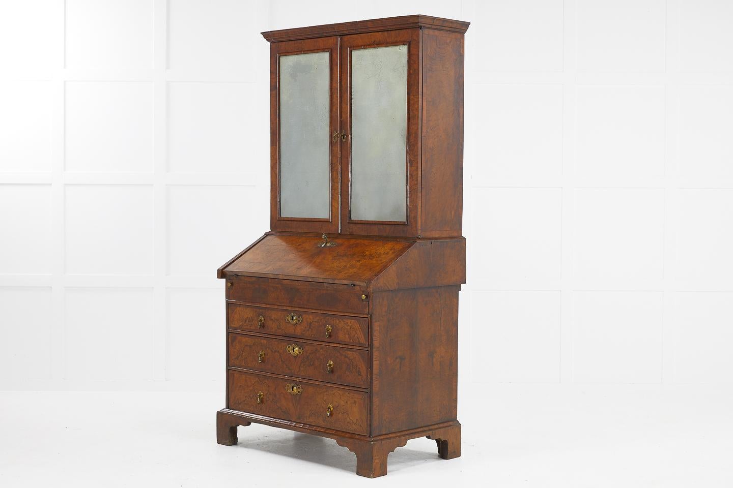English 18th century walnut bureau cabinet with nicely aged foxed glass doors.
Adapted during the late 19th century to make a charming furnishing piece.
  