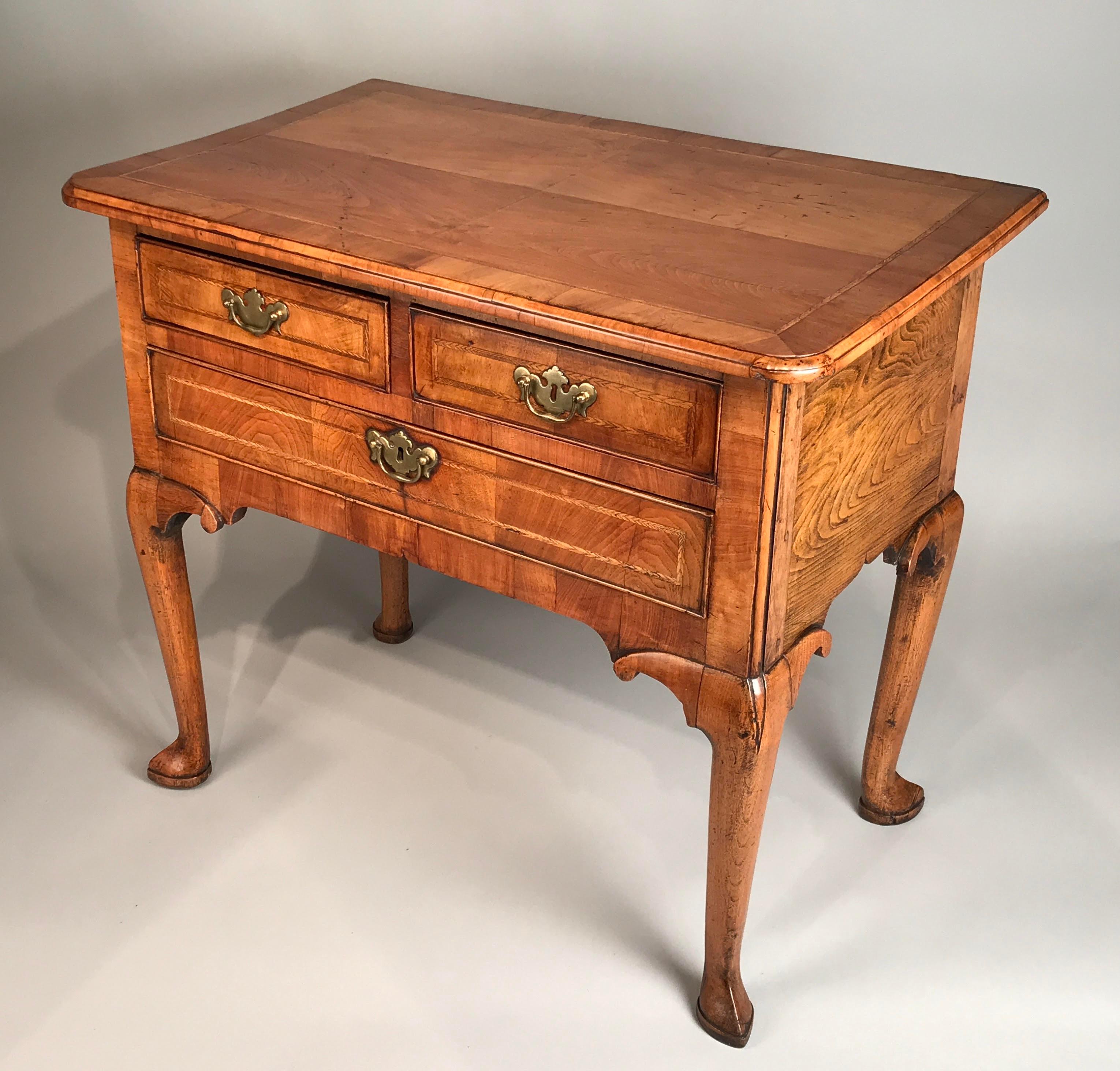 An English mid-18th century walnut lowboy. George II period, circa 1750.
Of excellent color and patina.

Nb. This mid-Georgian walnut lowboy may also be referred to as a side table, dressing table, writing table, or vanity.
Raised on elegantly-drawn