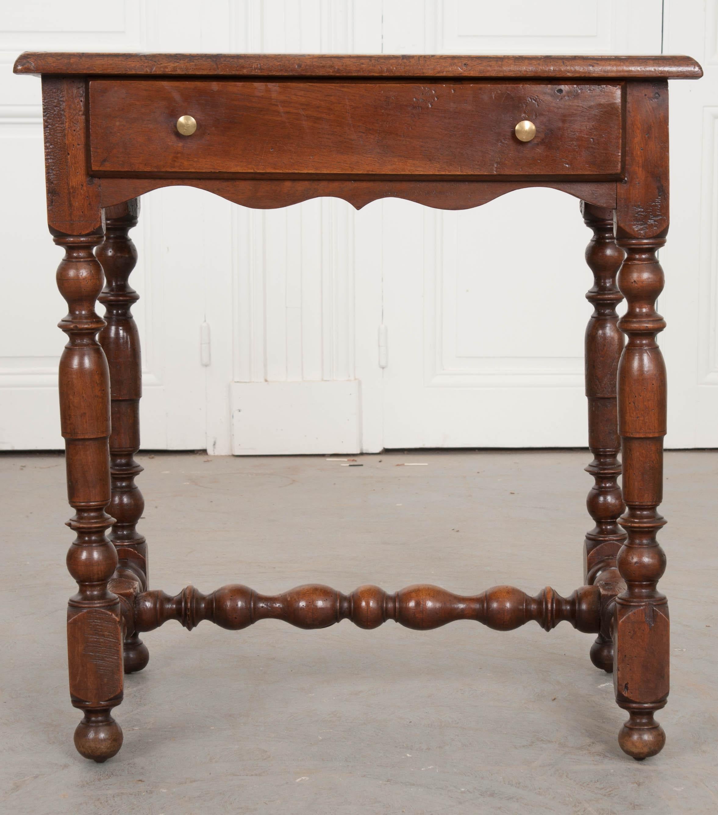 A fantastic solid-walnut table with drawer, dating to 1780s England. This small table would make a lovely drink or side table and also boasts storage. A wide drawer can be found in the table’s apron that will facilitate out-of-sight storage. It is