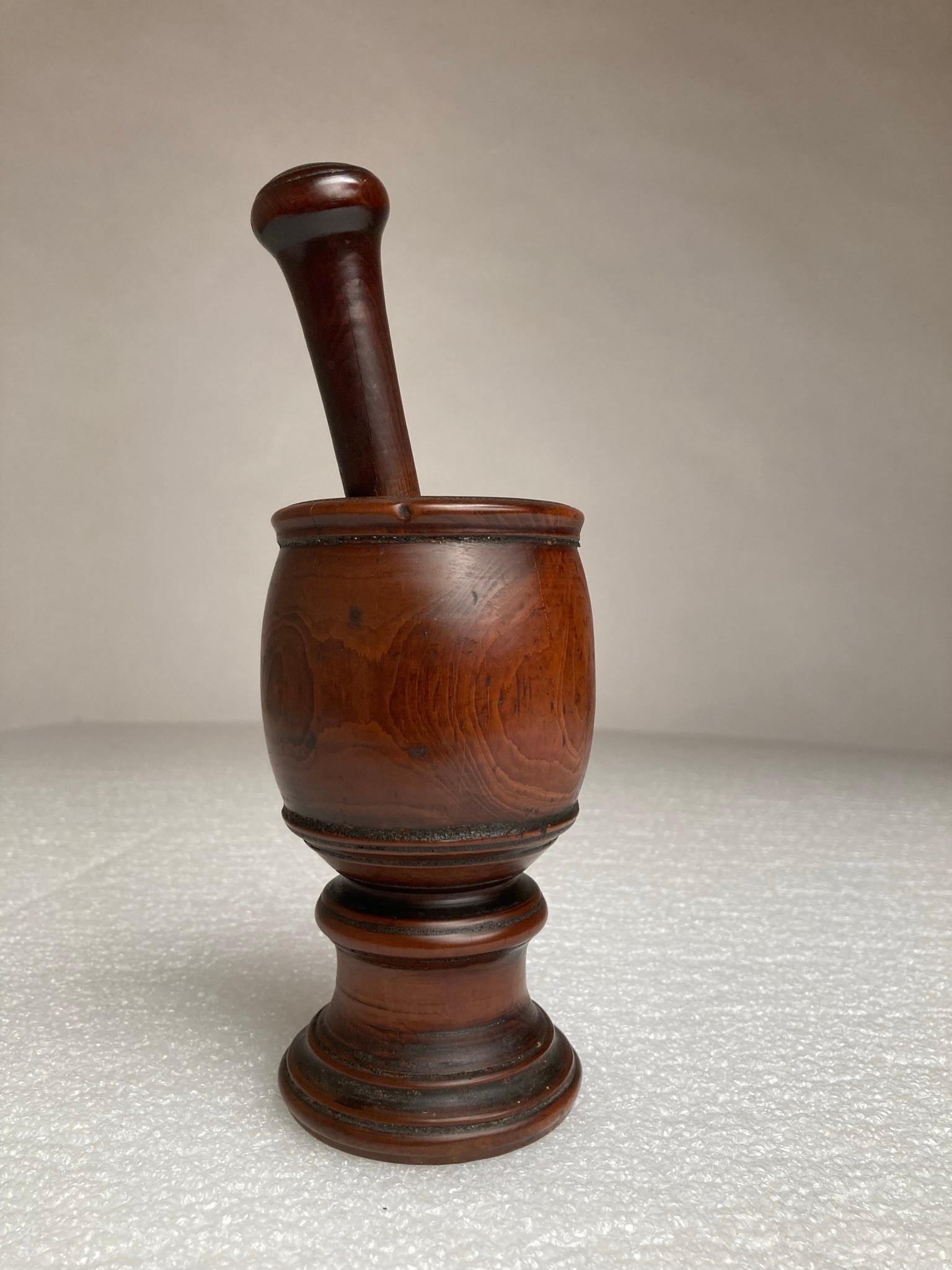 18th century English treen mortar and pestle hand turned and carved from yew wood with the rich and warm patina that only comes with age and use. Beautifully carved by hand from a single piece of yew wood. 
From a New York City private collection.