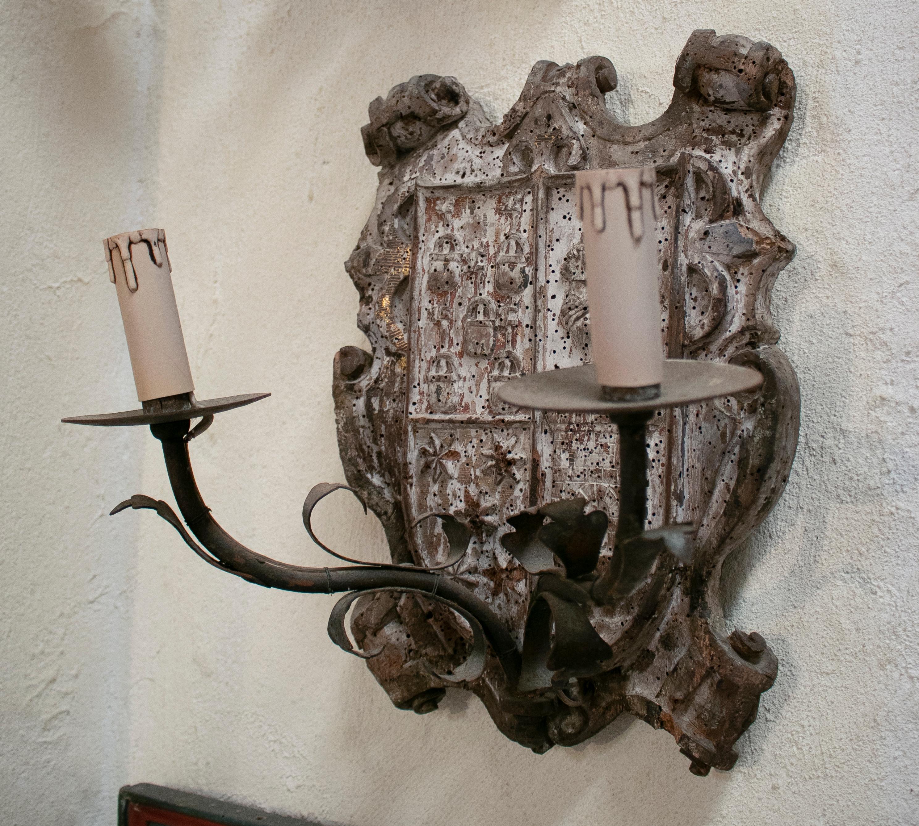 18th century European pair of wood crest two-arm sconce wall lamps.

           