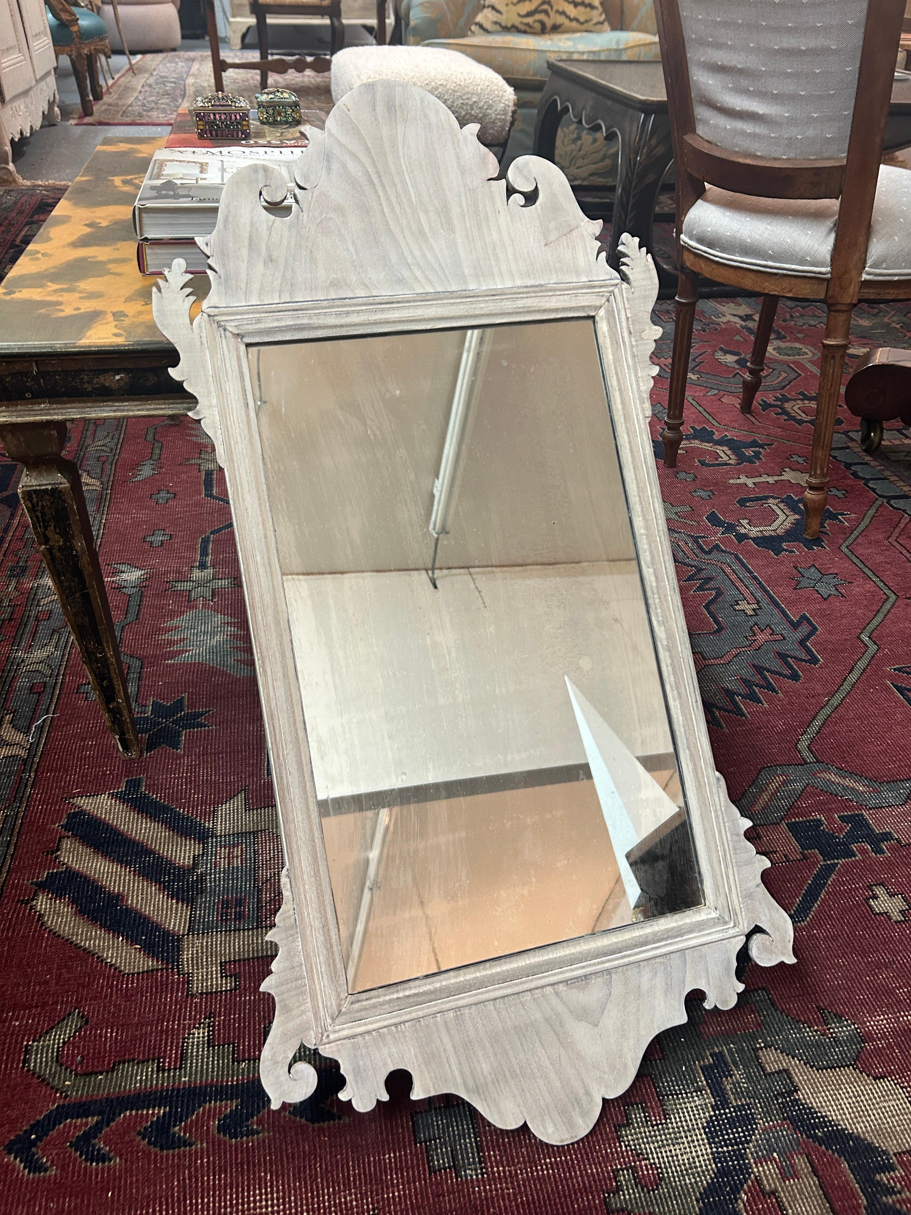 Enhance you or your client's home's elegance with this exquisite 18th Century Federal Mirror, crafted in the timeless Chippendale style. Made from lustrous bleached mahogany, this mirror exudes sophistication and charm. Its scroll-cut frame
