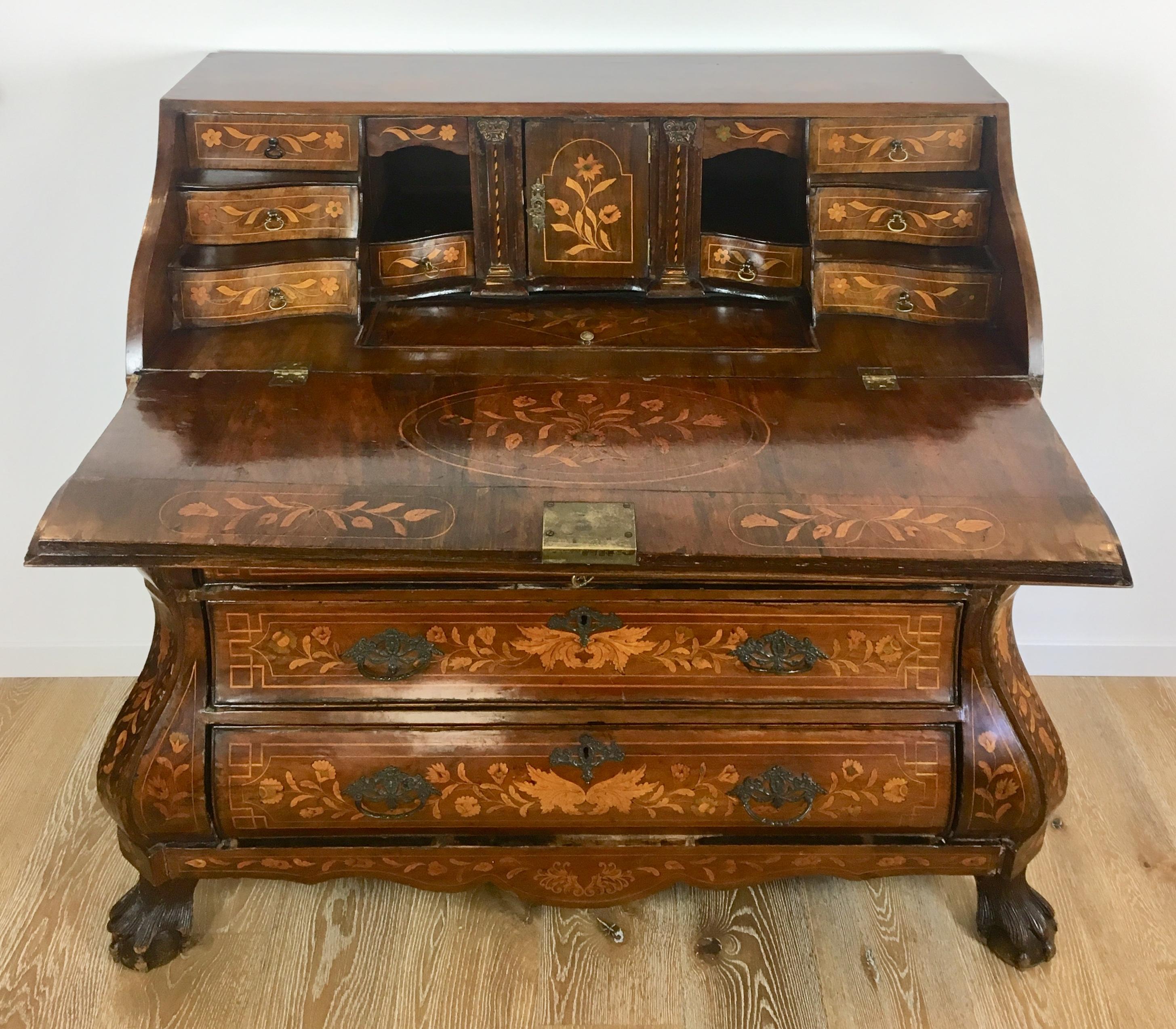 A fine 18th century Dutch scriban, secretary or commode, from Holland. 
Top lid, sides and front inlaid with flowers, urns of flowers and trailing vines. Three drawers with slant lid which opens to reveal a wonderful interior including eight drawers