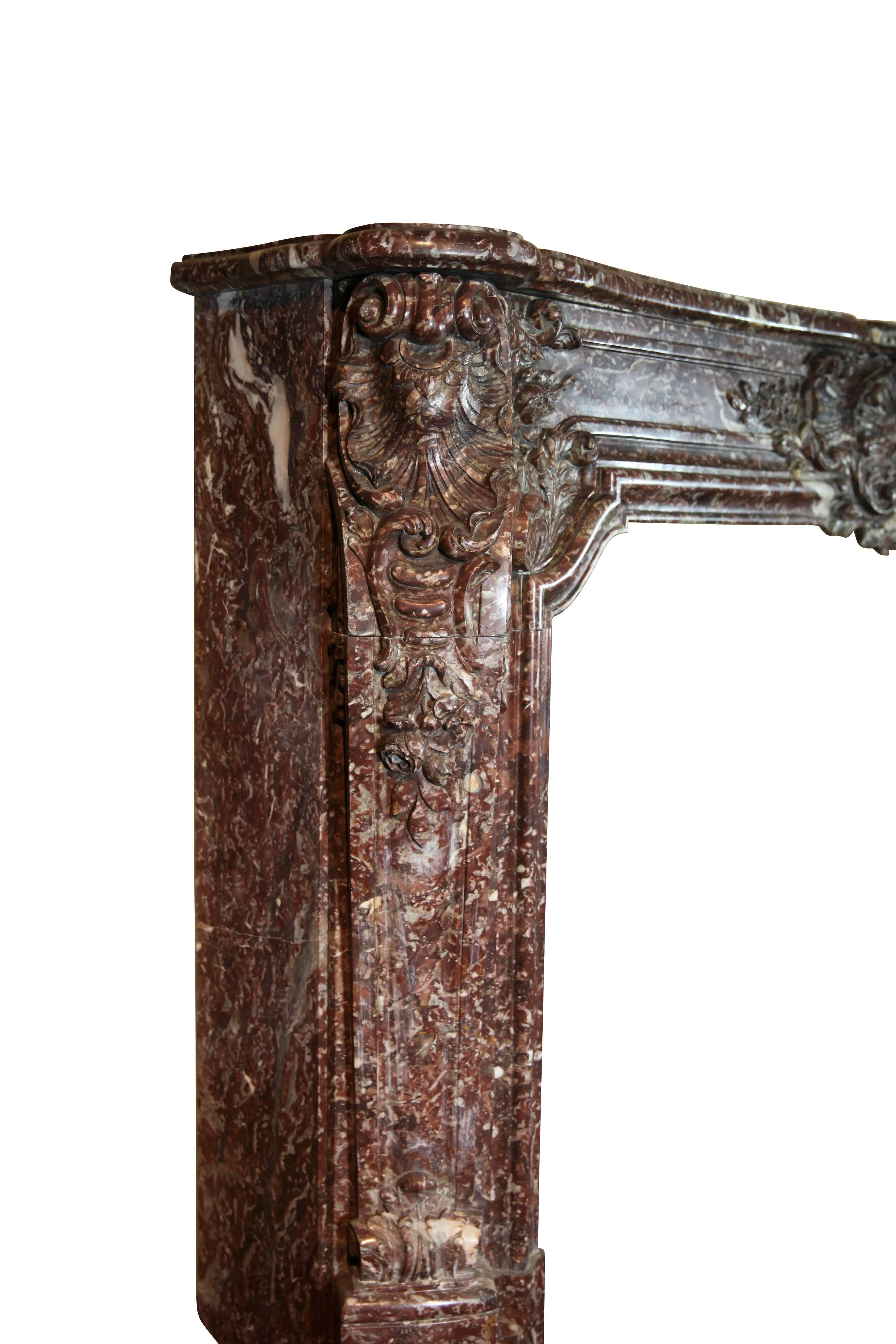 This is a massive, grand, original antique fireplace mantel (fireplace) made in the Belgian Marble de Rochefort, affiliated with abbey de Rochefort, well known for its famous Belgian Beer. It is an exceptional chimney piece from a Belgian palace.