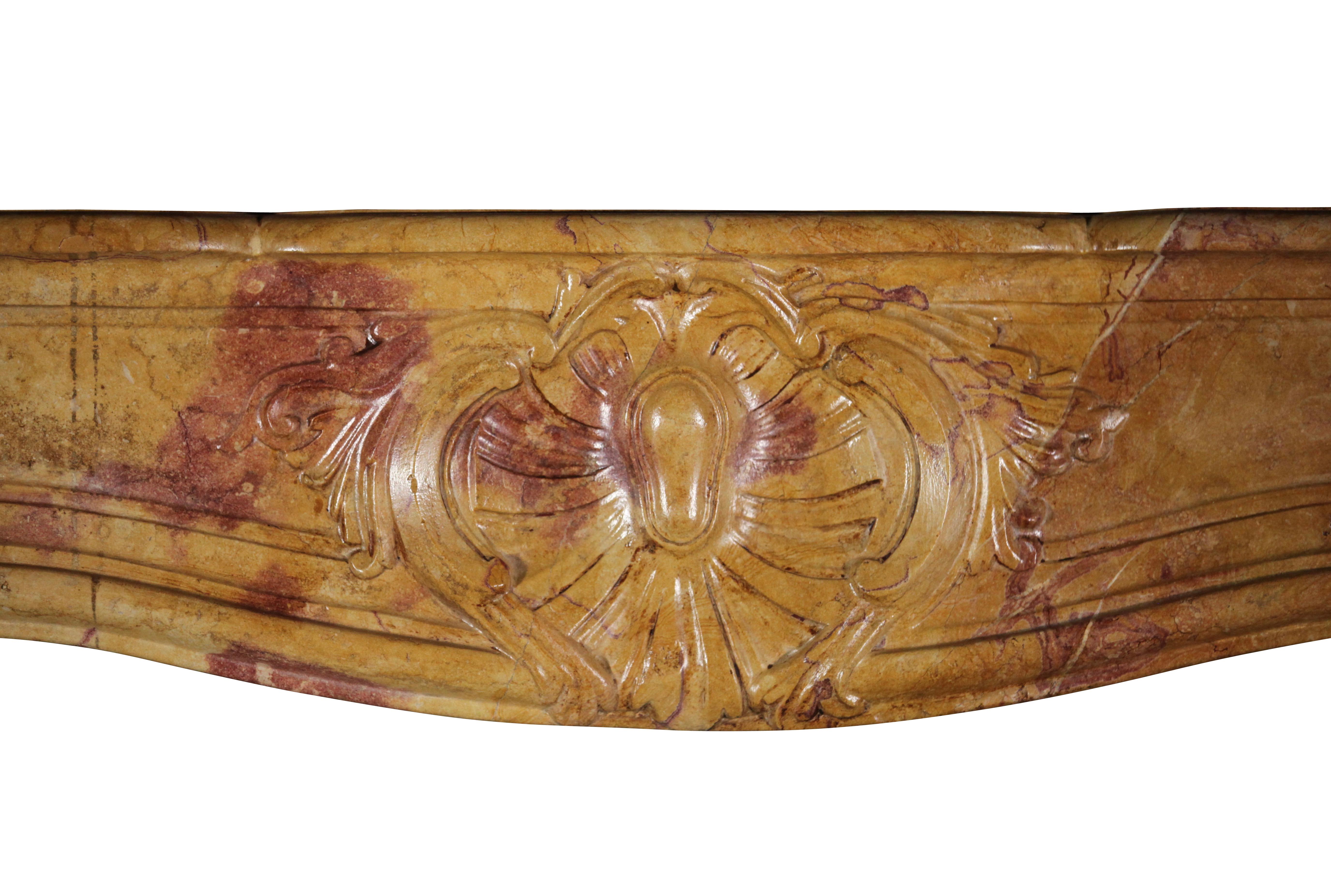 This is a very unique, once in a lifetime, original antique fireplace surround in deep color hardstone out of the Corton vinyard area in France. Early French Régency period. This mantle works in grand interiors with grand art; from Classic to most
