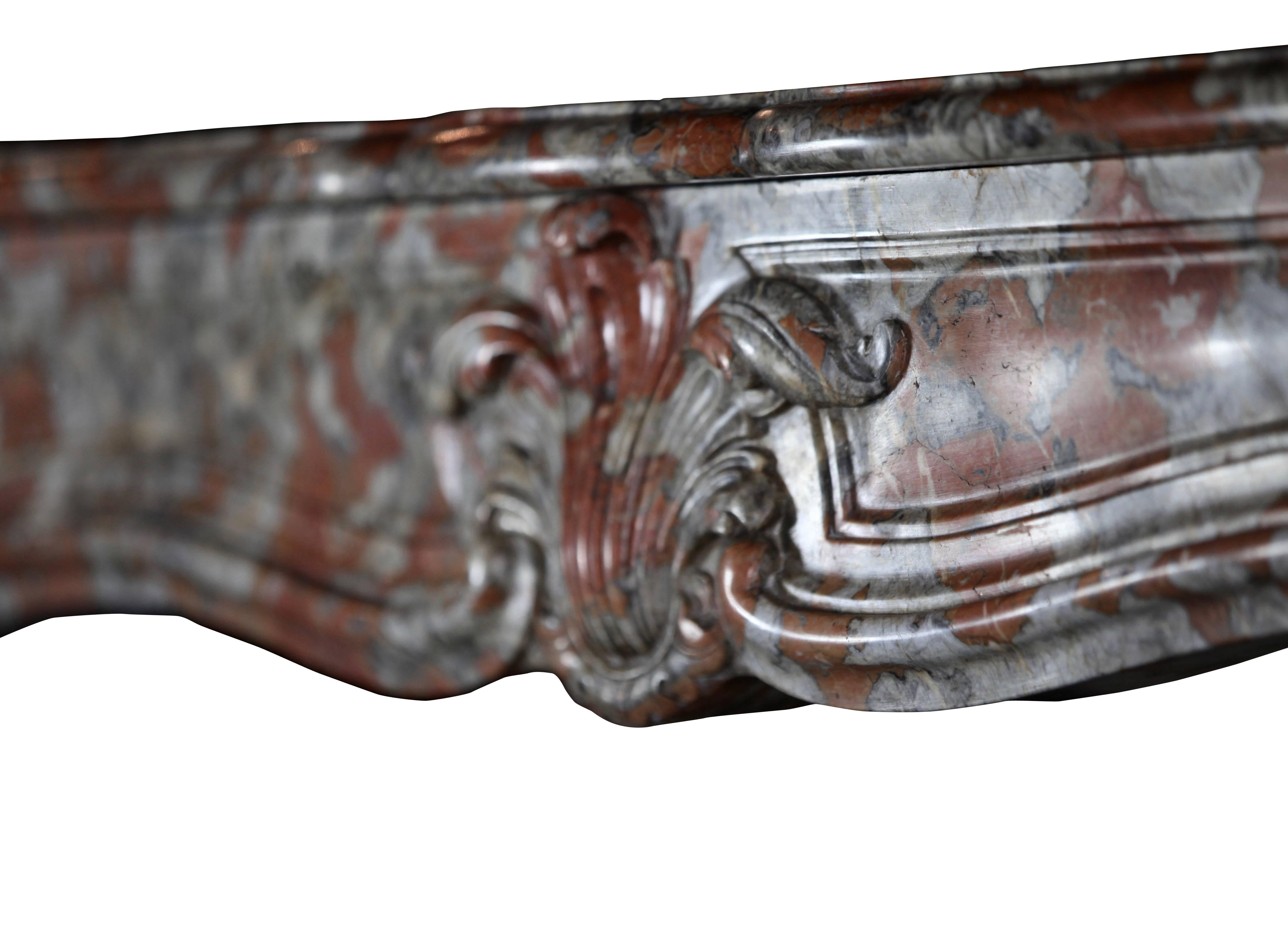 This is a very unusual French petite mantel piece crafted from the bespoke Rouge Languedoc marble. Rouge Languedoc marble is one of the most used marbles in French castles. It was exported all-over the world. One can find this marble in some