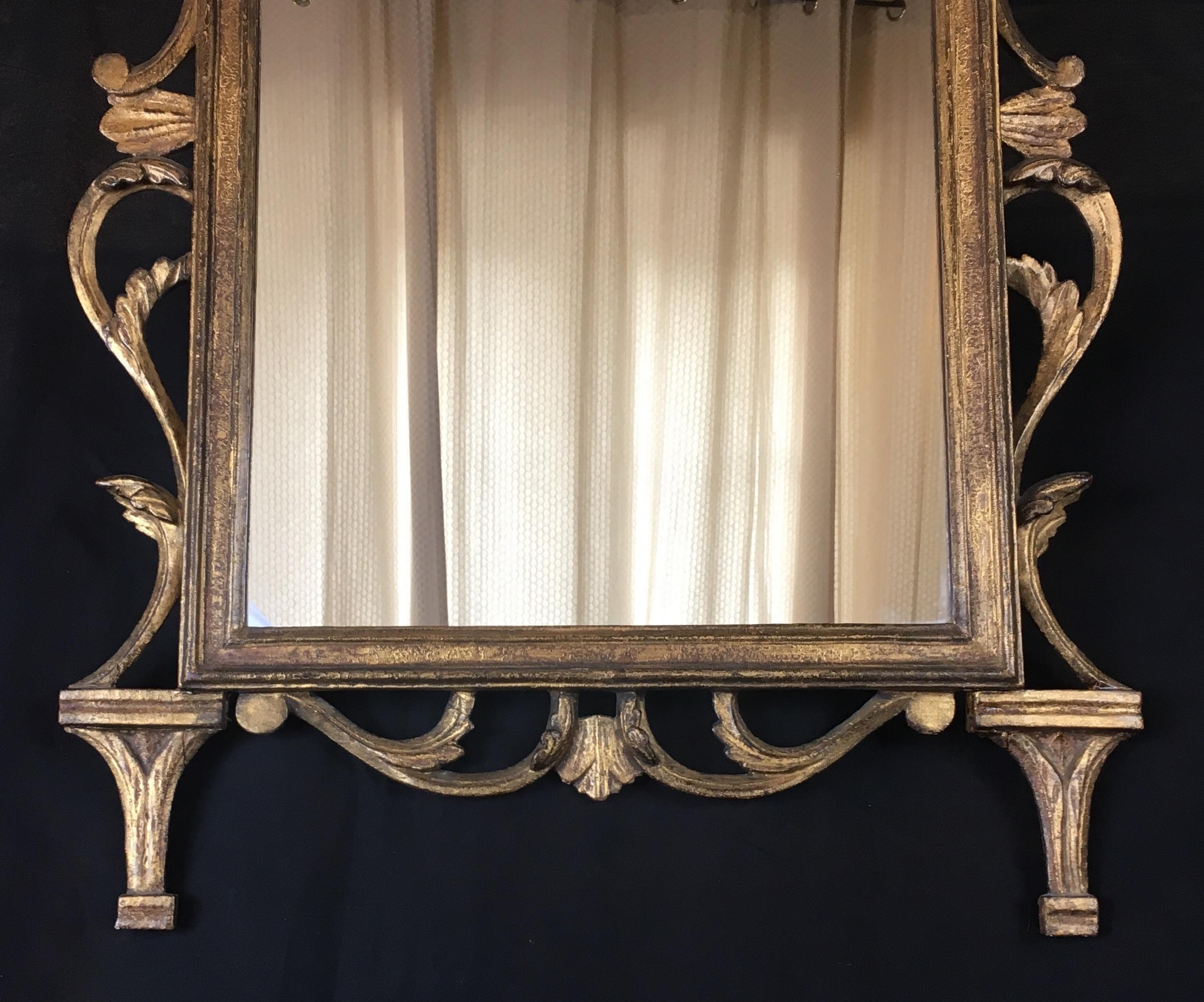 A fine 18th century Regency gilt wood mirror with a filigree border and pediment having a scalloped design.

Original gilding.
Fine hand-crafted carving. 

 
