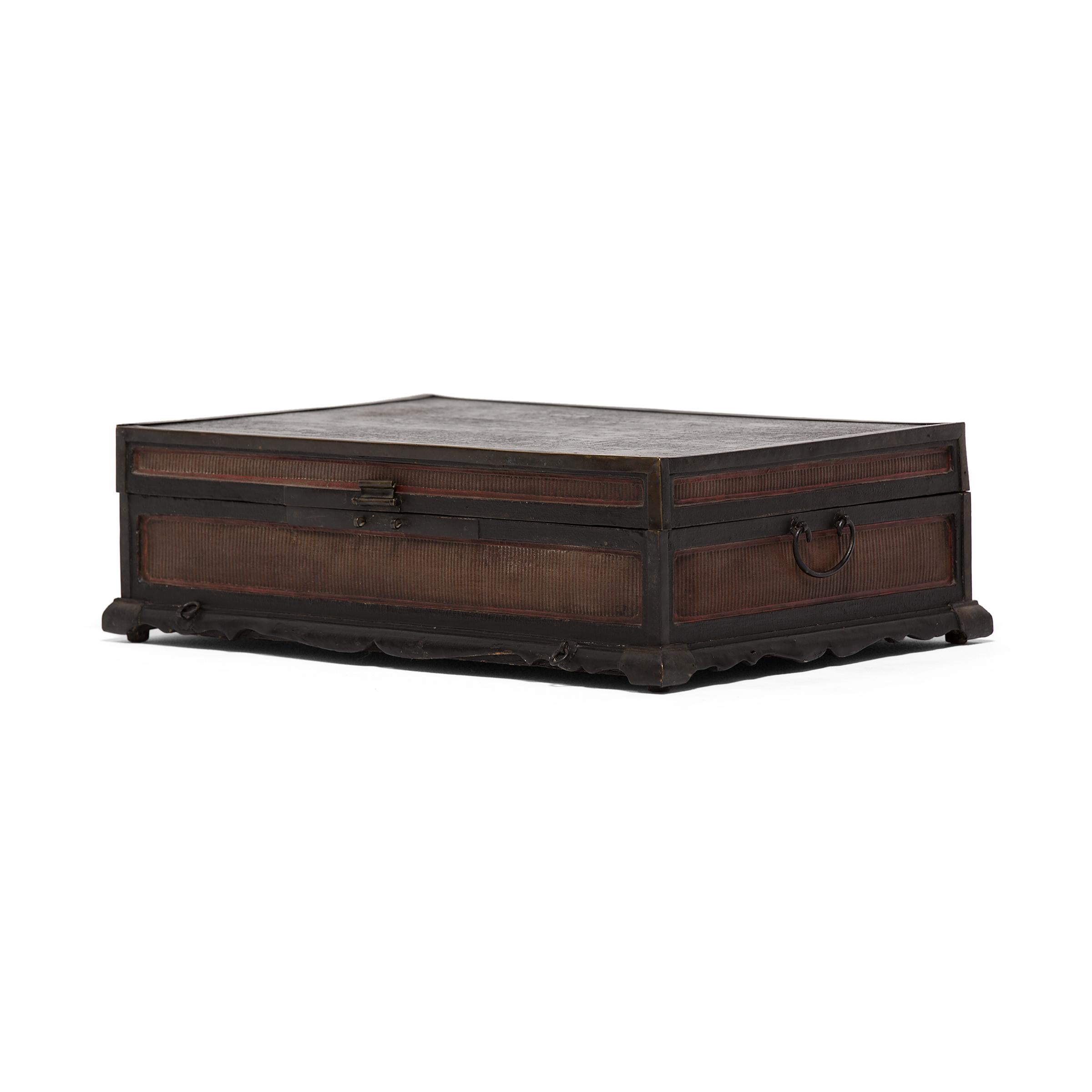 This 18th-19th century finely woven trunk was originally used to safely store painted scrolls. A skilled artisan painstakingly wove thin-as-hair reeds to cover each of the side panels, protected and reinforced by original brass corner mounts. The