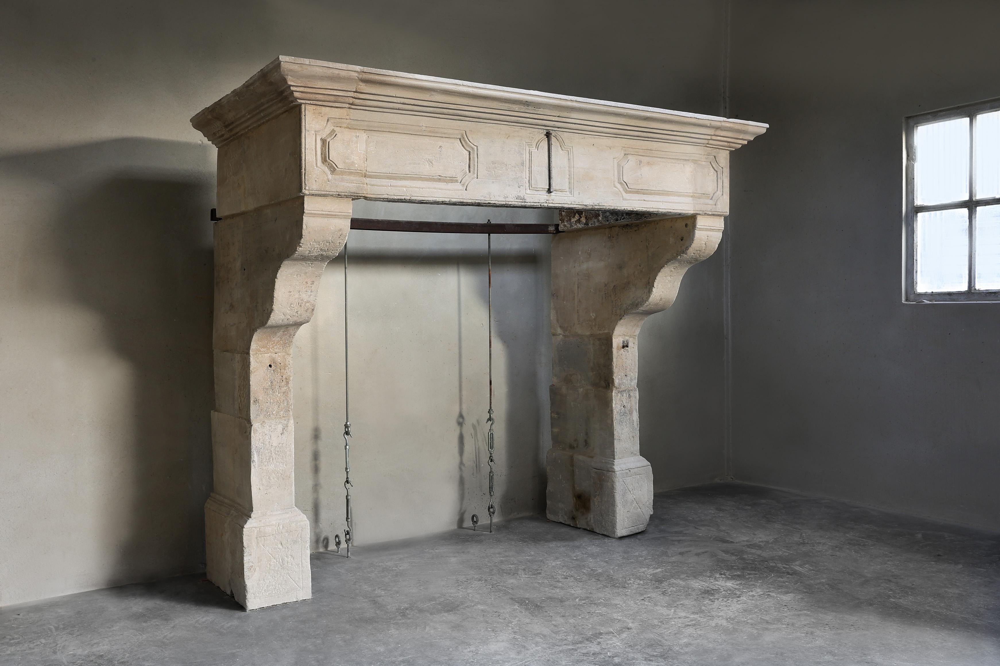 Very imposing antique castle fireplace from the 18th century! A beautiful fireplace in the style of Louis XIII with various ornaments and gravings and beautiful lines in the top of the fireplace. This French limestone fireplace has allure and
