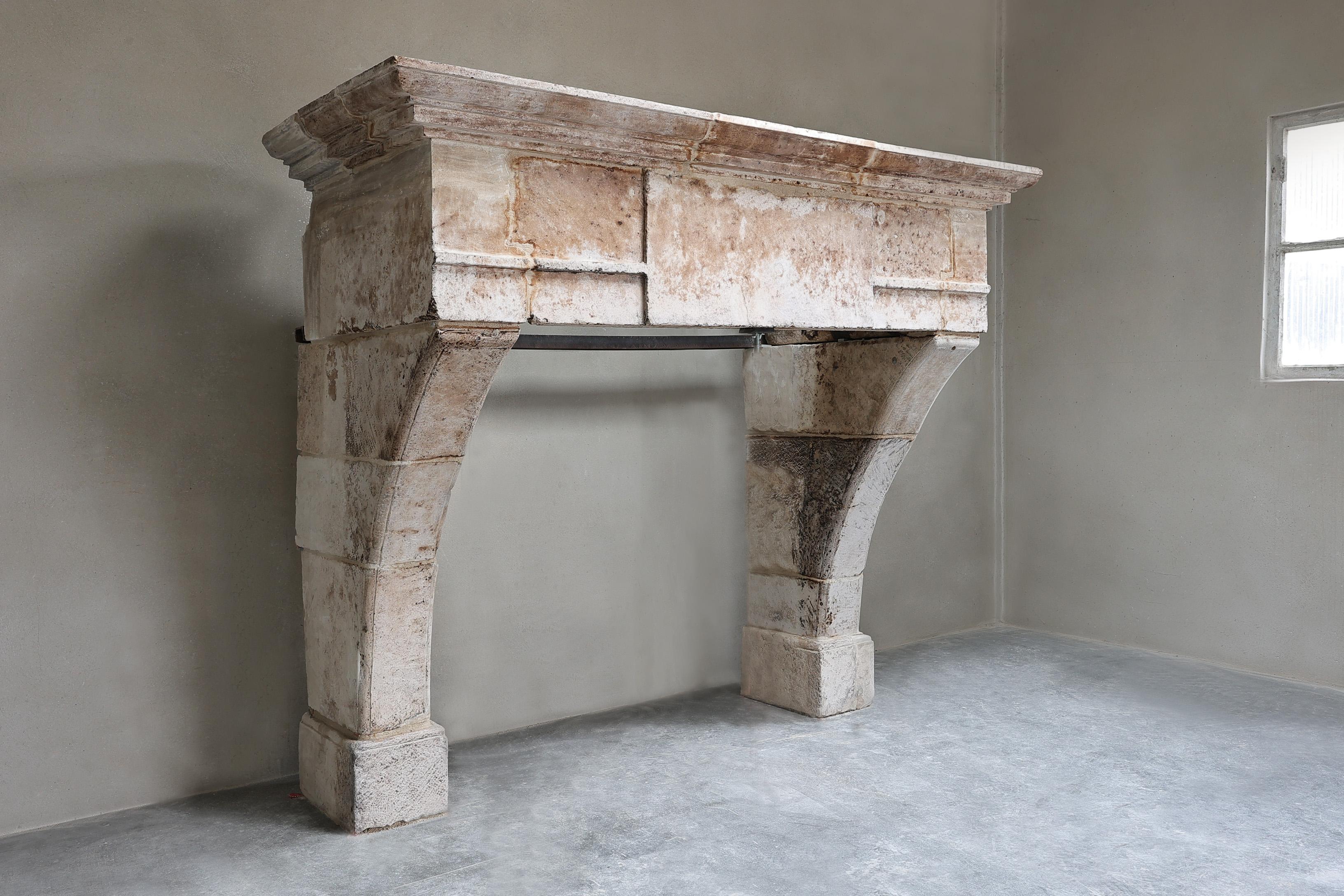 Beautiful imposing castle mantelpiece made of French limestone! A very robust antique fireplace from the 18th century with a wide front section and slender legs. This fireplace is both an eye-catcher for your interior and an added value for your