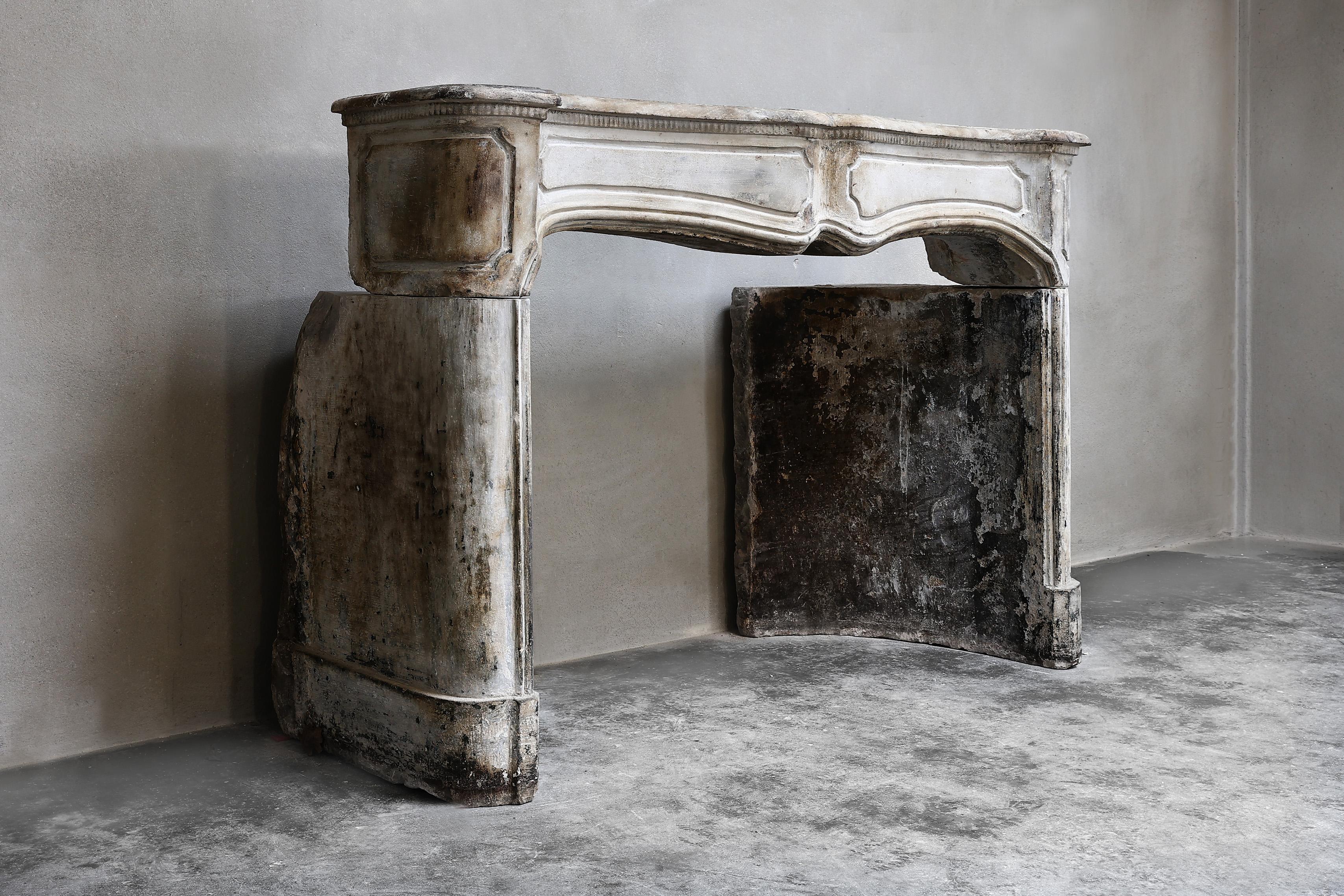 Unique and special fireplace of French limestone from the 18th century. This antique mantle comes from the old town of Bordeaux and has a beautiful color scheme and beautiful round shapes. This fireplace is in the style of Louis XV, has beautiful