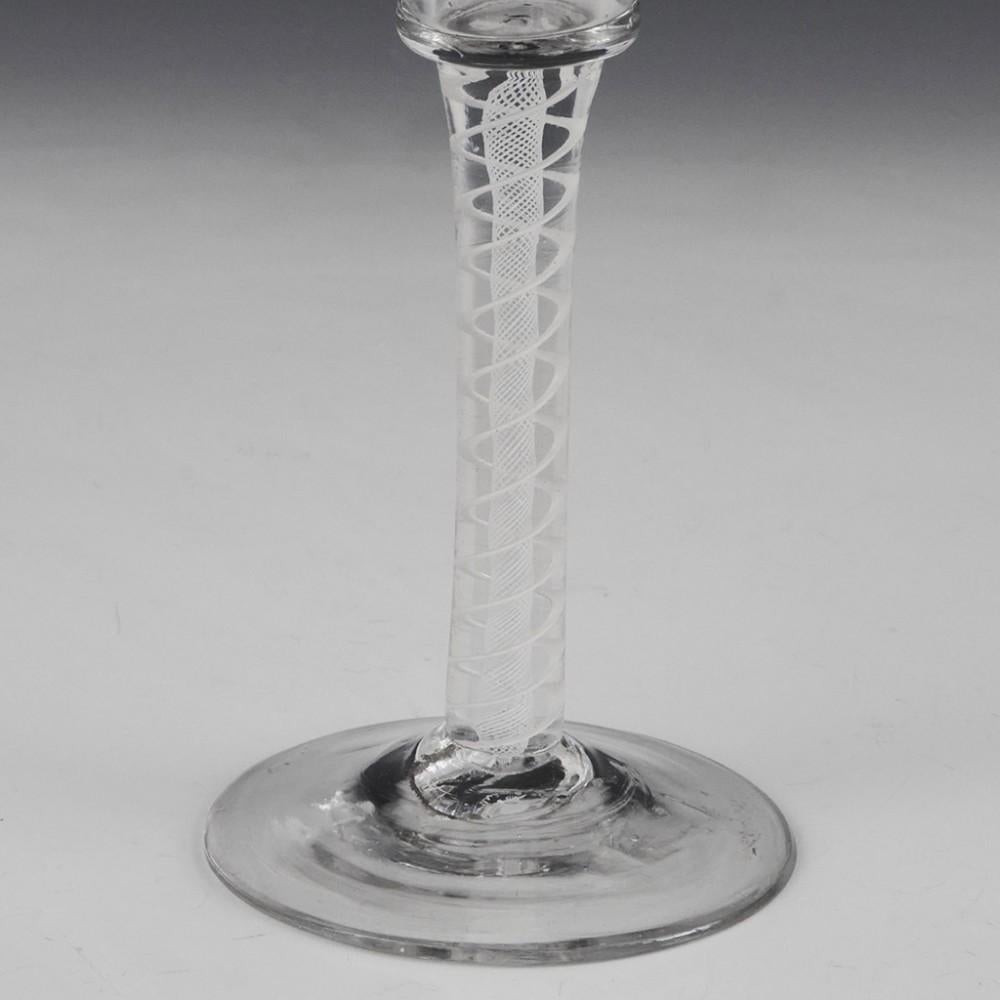 Heading : Single series opaque twist stem Georgian wine glass
Period : George II / George III - c1760
Origin : England
Colour : Clear
Bowl : Waisted bucket.
Stem :  A pair of spiral tapes putside a multi-ply core
Foot : Conical
Pontil :