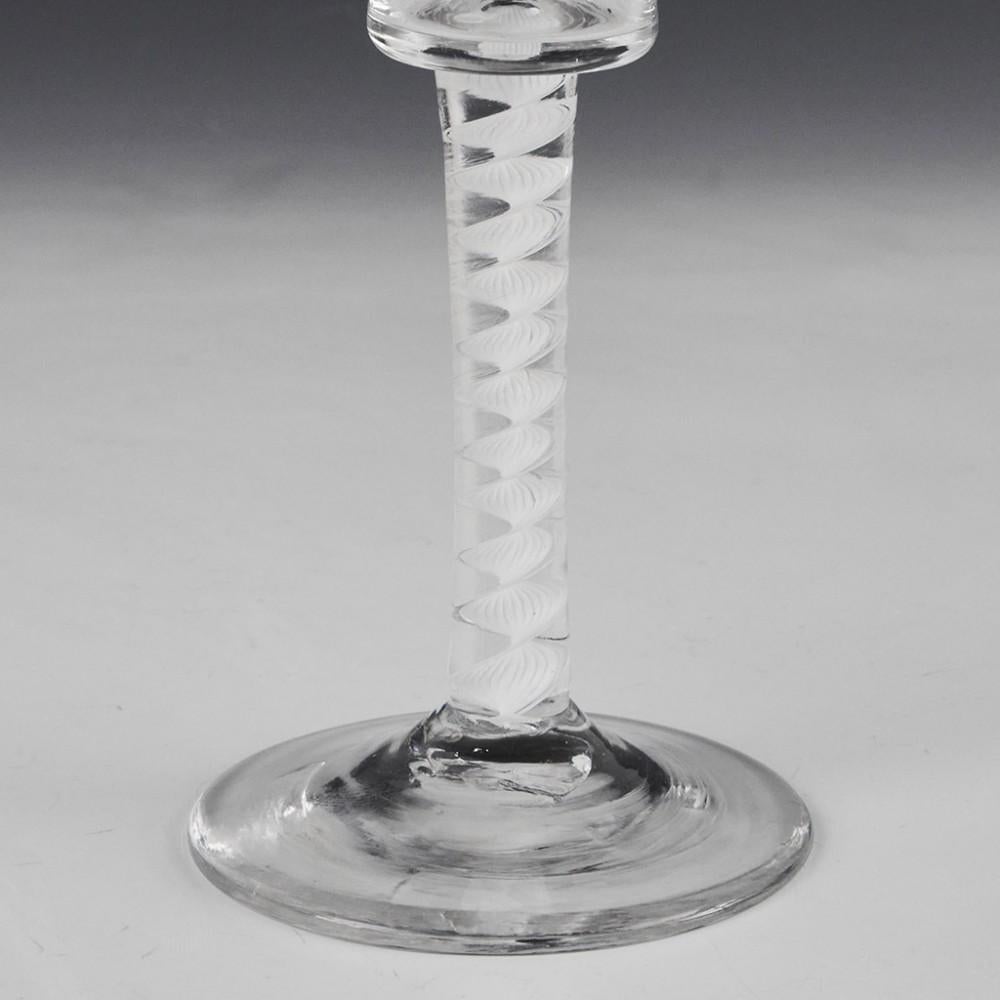 Heading : Single series opaque twist stem Georgian wine glass
Period : George II / George III - c1760
Origin : England
Colour : Clear
Bowl : Waisted bucket.
Stem : Mult-ply corkscrew
Foot : Conical
Pontil : Snapped
Glass Type : Lead
Size :  14.9cm