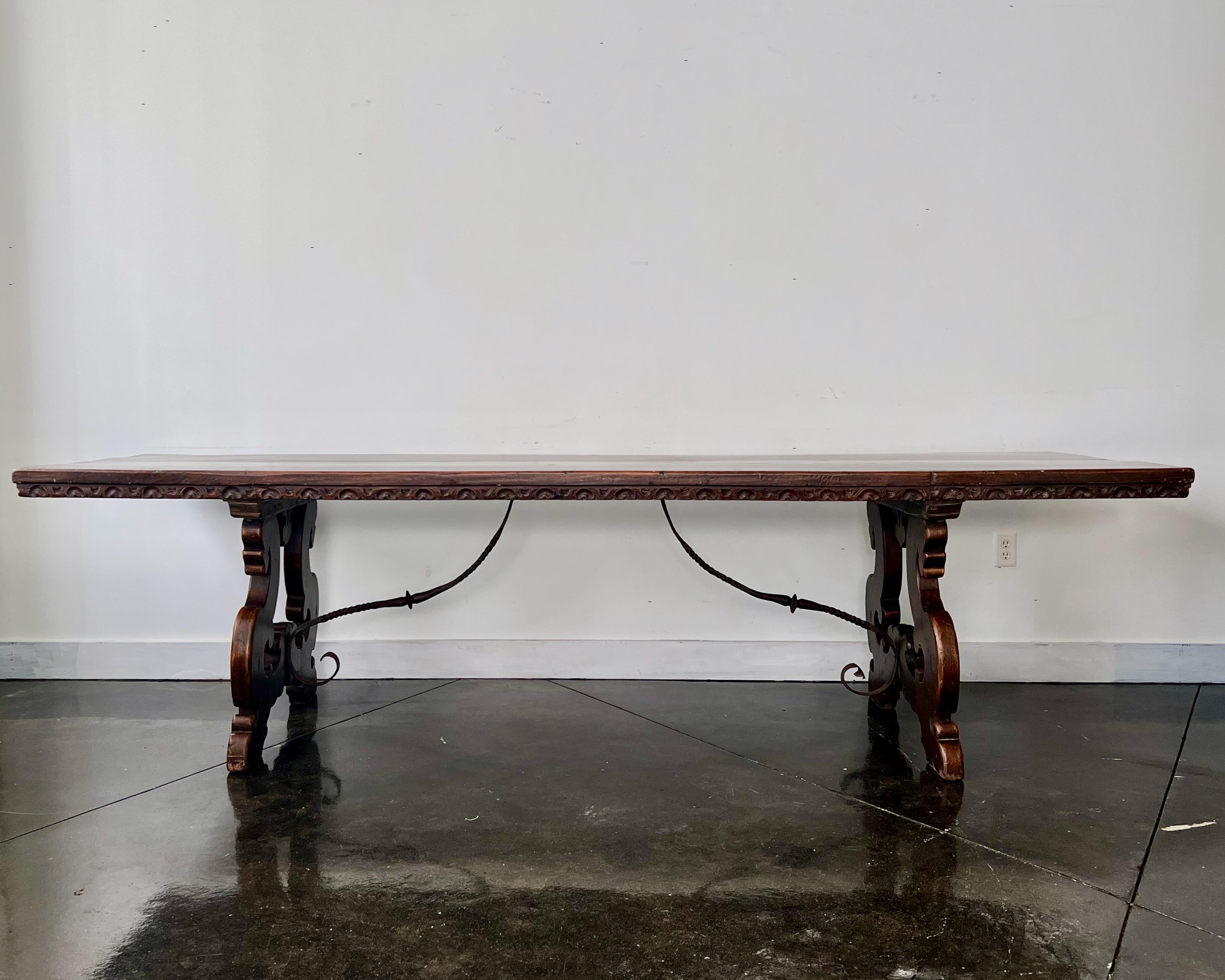 18th century, Florentine Italian walnut dining table with Lyre legs, hand forged iron stretcher base topped with carved edge, long thick walnut top in rich brown patina.
Florence, Italy, 18th century
