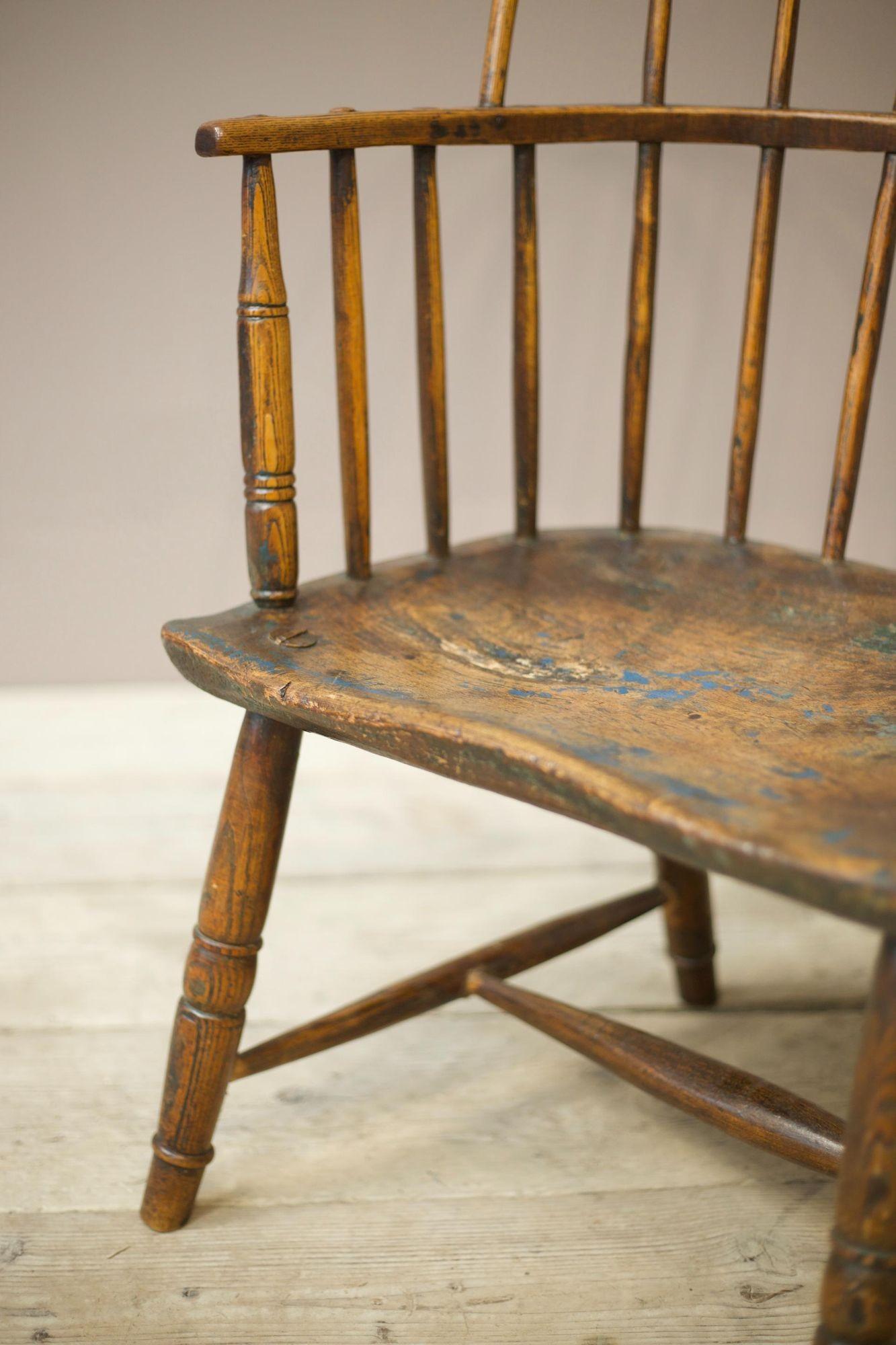 This a very attractive primitive folk art 18th century stick back Windsor chair. Great overall condition with a huge amount of originality including remains of blue and green paint. The back hoop is made from one single piece of bent timber which