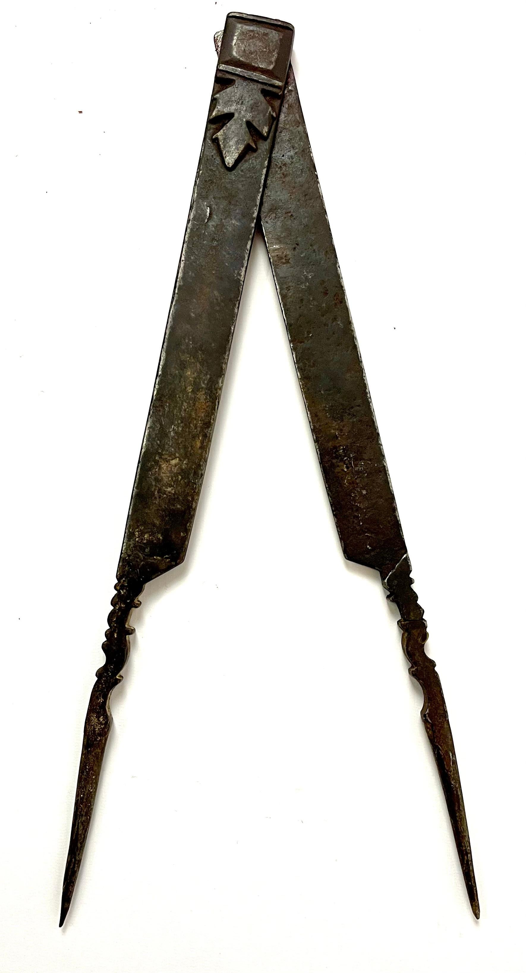 This extraordinary 18th-century forged steel compass is a striking piece of historical craftsmanship. Once used by master builders to create the architectural wonders of the Gothic era, such as Notre-Dame de Paris, this compass also carries deep