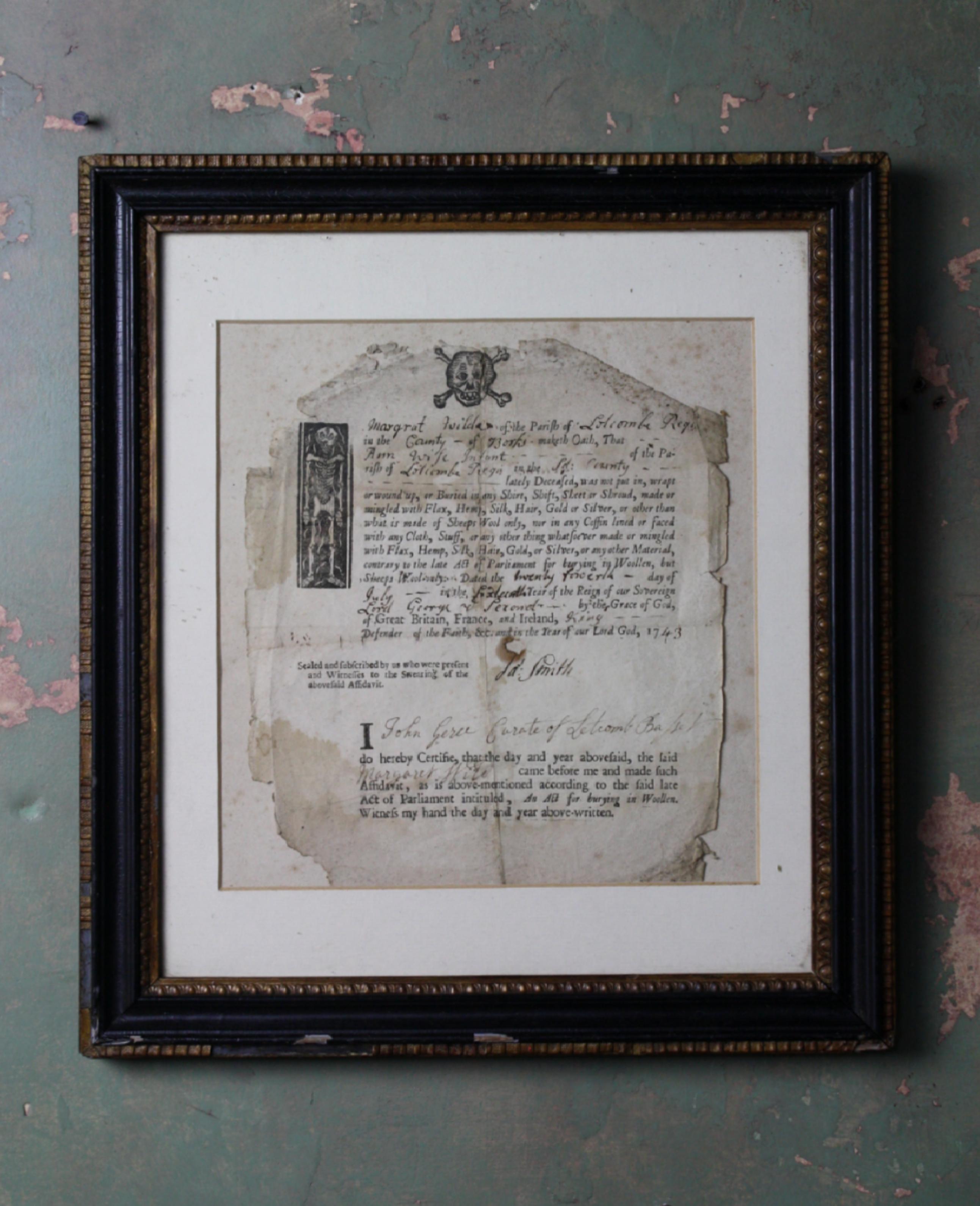 A parish document declaring that the infant Ann Wild has been buried only in sheep wool, the document is dated 1743 with wood-engraving of a skull at head and a skeleton in a coffin in margin, printed text with manuscript insertions, hole not