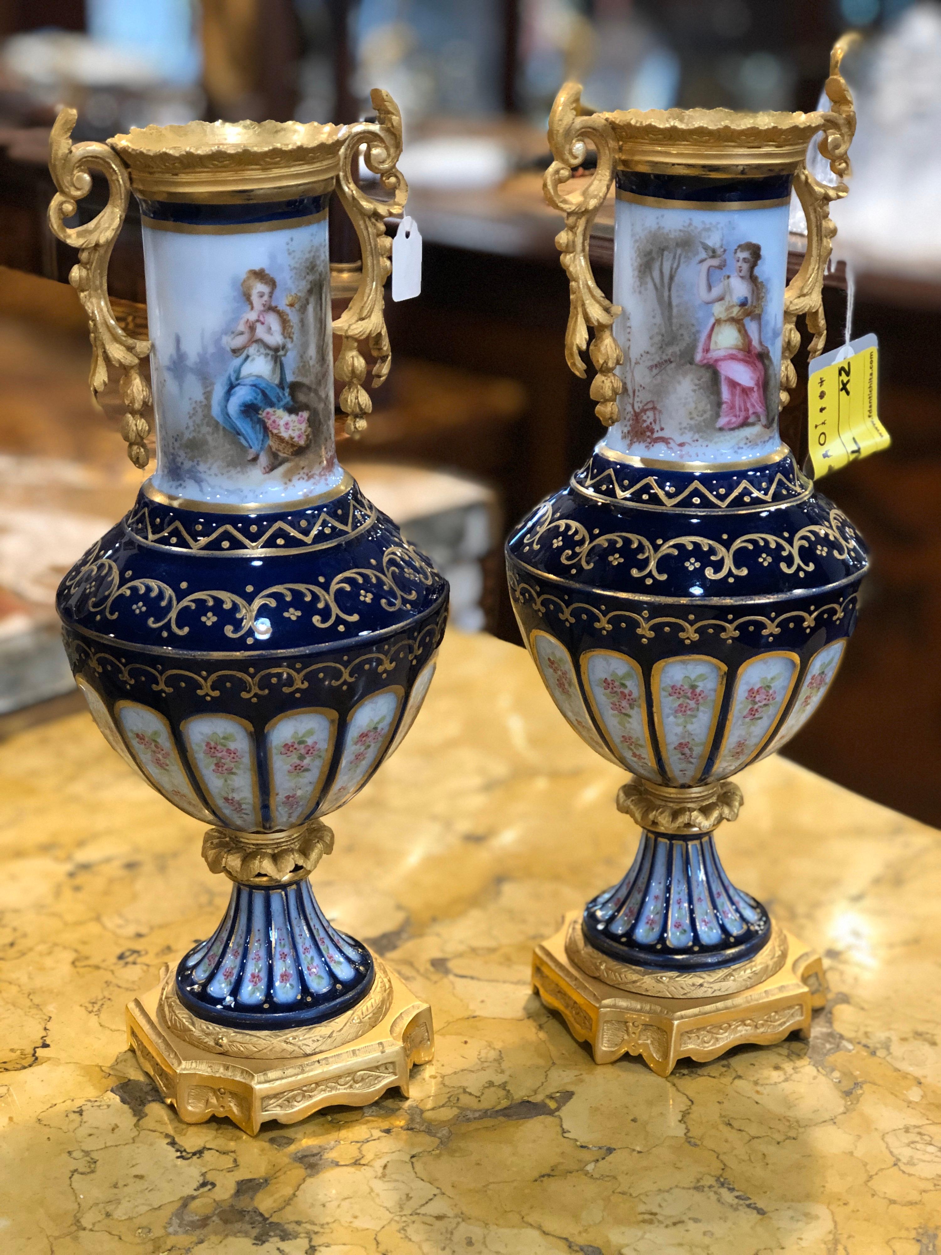 Pair of French flower vases, stamped under the base with Sévres brand, finely hand painted and in one color. Very intense blue, mercury-gilded bronzes with the original gilding, also finely ceased and of excellent fusion.