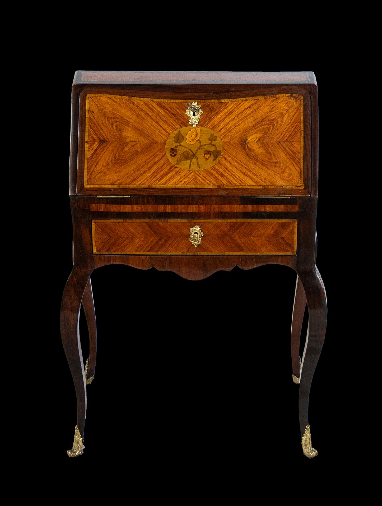 Very rare French chest-shaped, centerpiece bureau in purple ebony wood with mercury-gilt bronze appliqués.
Furniture of rare beauty by the finest French craftsmen of the period. A piece of furniture with a graceful form of rare beauty, the