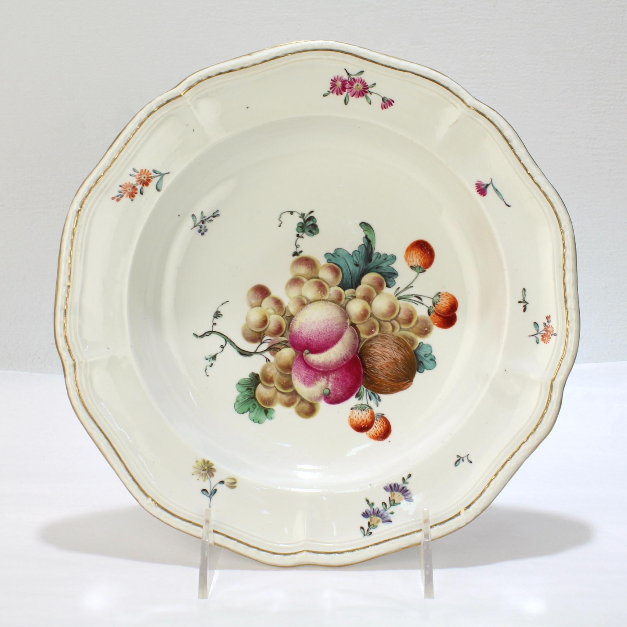 A very fine antique 18th century porcelain bowl.

By Frankenthal during the Carl Theodor period.

With a group of polychrome enamel decorated fruit and nuts to the bowl, floral sprays to the border, and a gilt edged, molded rim.

Simply a