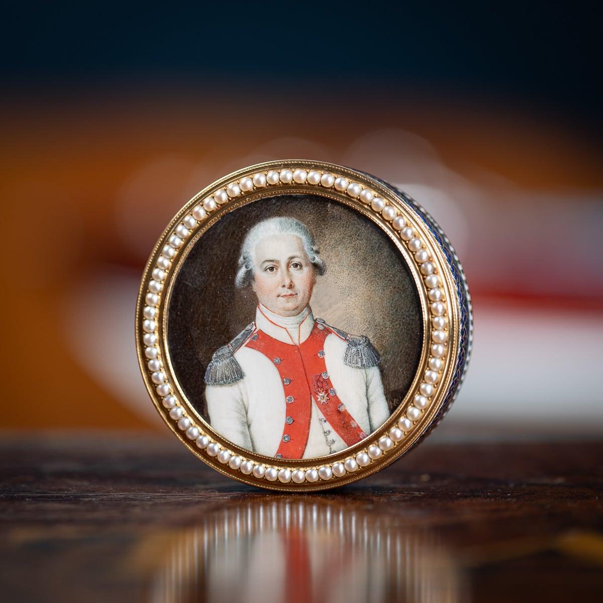 Antique 18th Century Exceptional French 18k gold & enamel snuff box, a circular snuffbox crafted in solid gold, adorned with blue, green, and white enamels, further enhanced by gold spangles and pastilles. The intricate design features festoons,