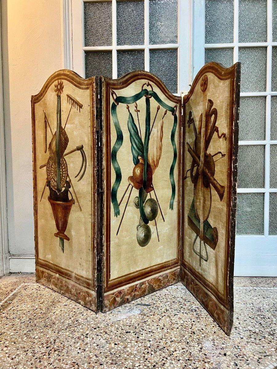 Presenting you this 18th-century antique three-leaf folding screen with oil-on-canvas paintings on the front and oil-on-paper paintings on the back. 

Some tears consistent with the age and use of this piece can be seen in the paper on the reverse,