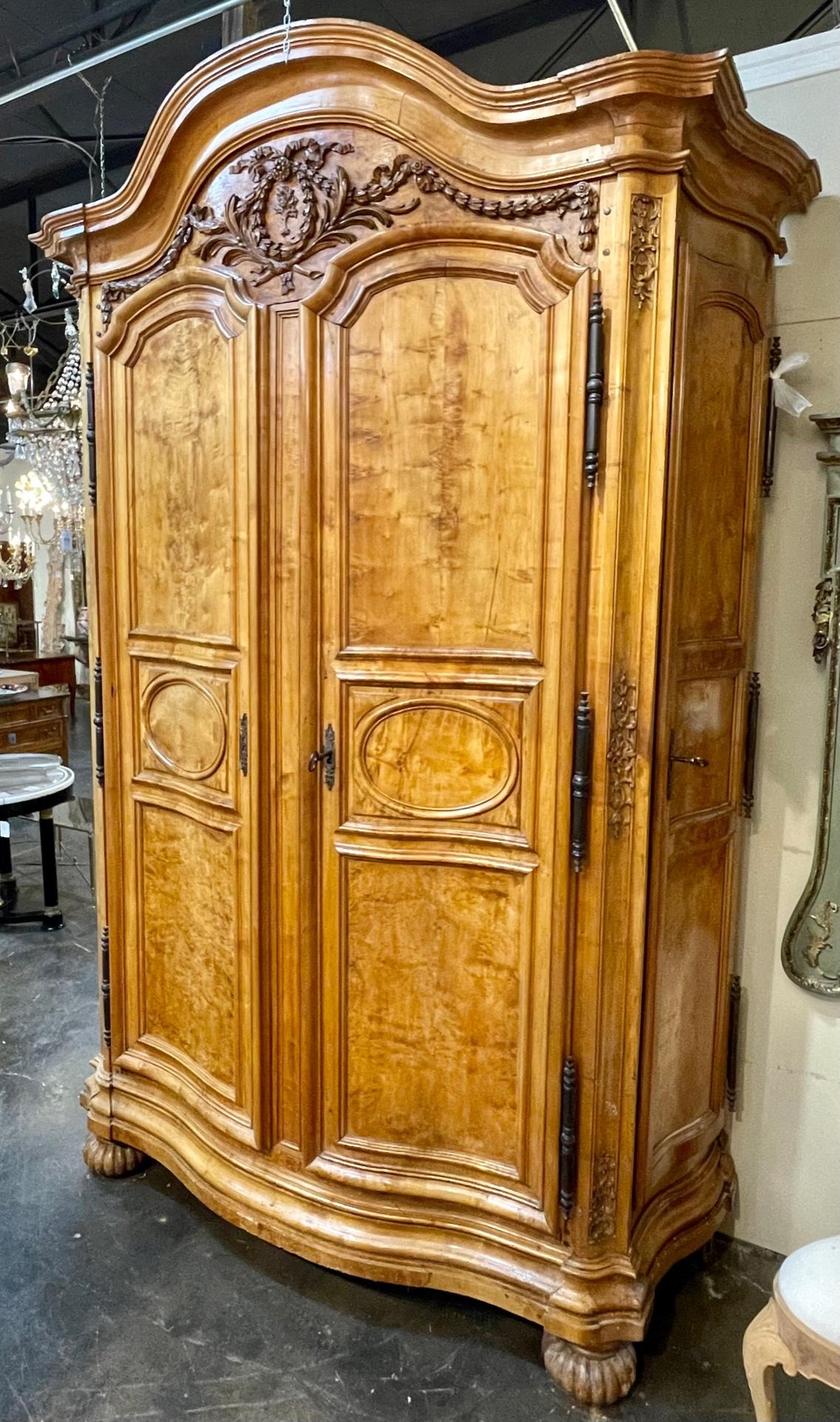 Outstanding 18th century French carved burl walnut four door armoire from Lyon. This stunning piece has so many functions. It could be a wonderful coffee bar, stemware storage, as well as linen storage. This piece is sure to make a statement.