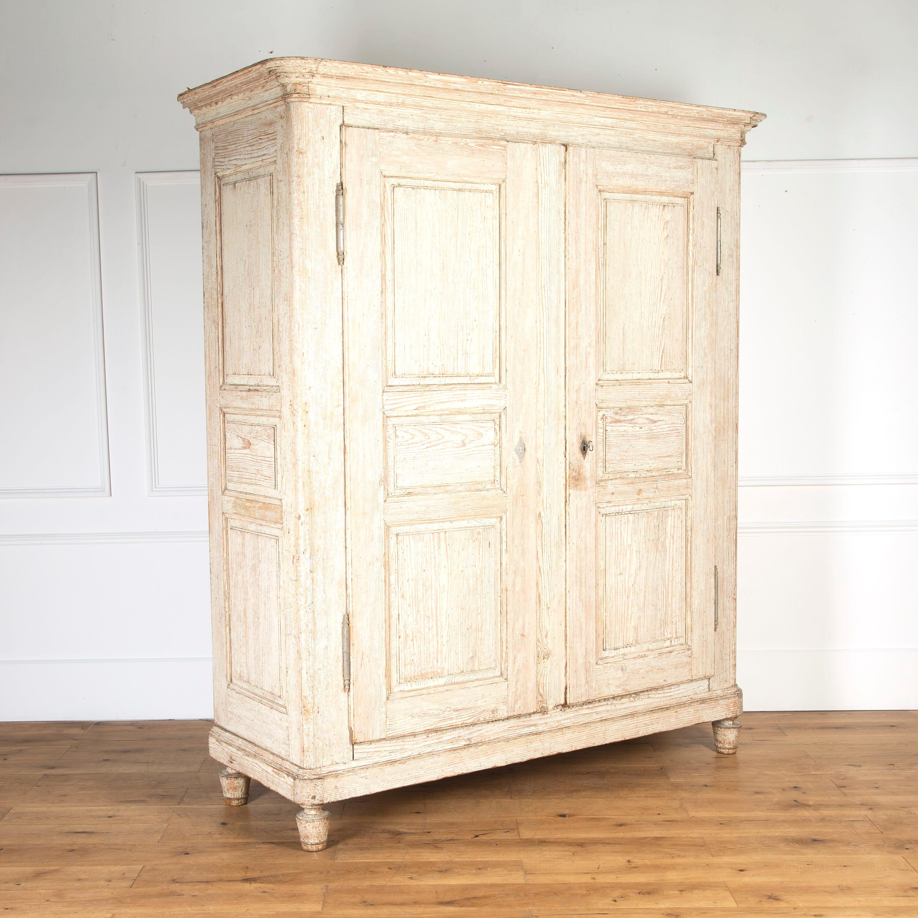 Stunning 18th Century French armoire. 

This armoire comes from the Alsace region of France.

It has been dry-scraped back to its original painted finish which is an attractive white.

Features a decorative carved cornice above two panelled