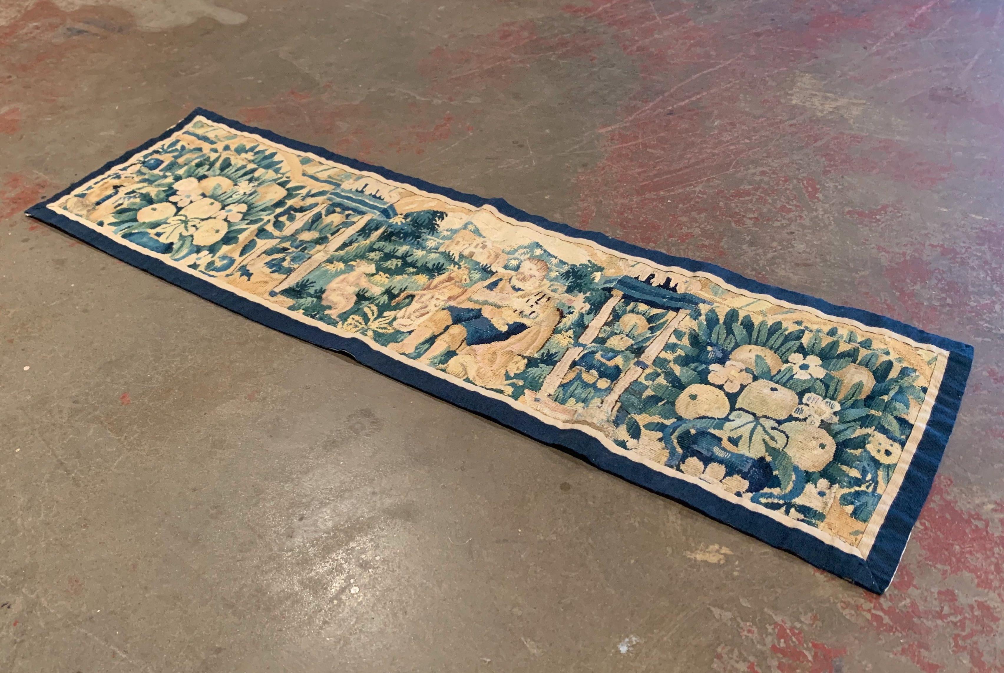 Dress a dining room table with this antique runner; handwoven in Aubusson France circa 1760, the tapestry features a center medallion depicting a wisdom man teaching a youngster, and is flanked with ruins, fruit and floral motifs on both sides. The