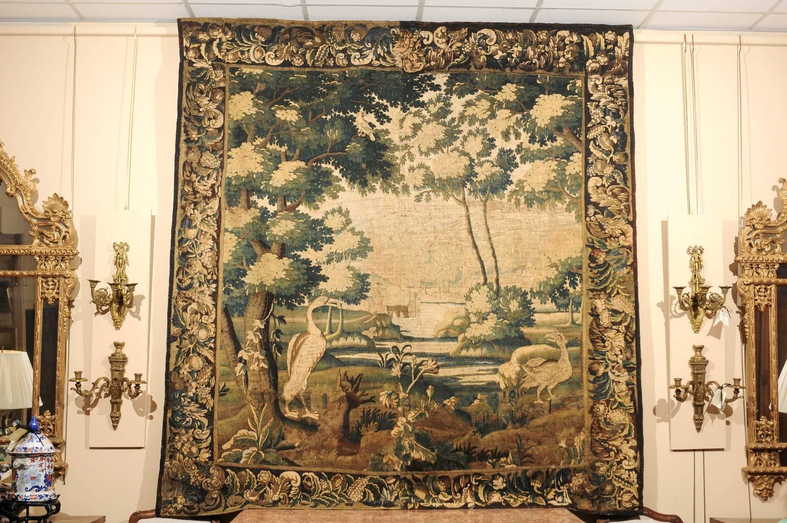 The 18th century French Aubusson tapestry with landscape scene in green, brown and tan hues. New linen backing. 

  