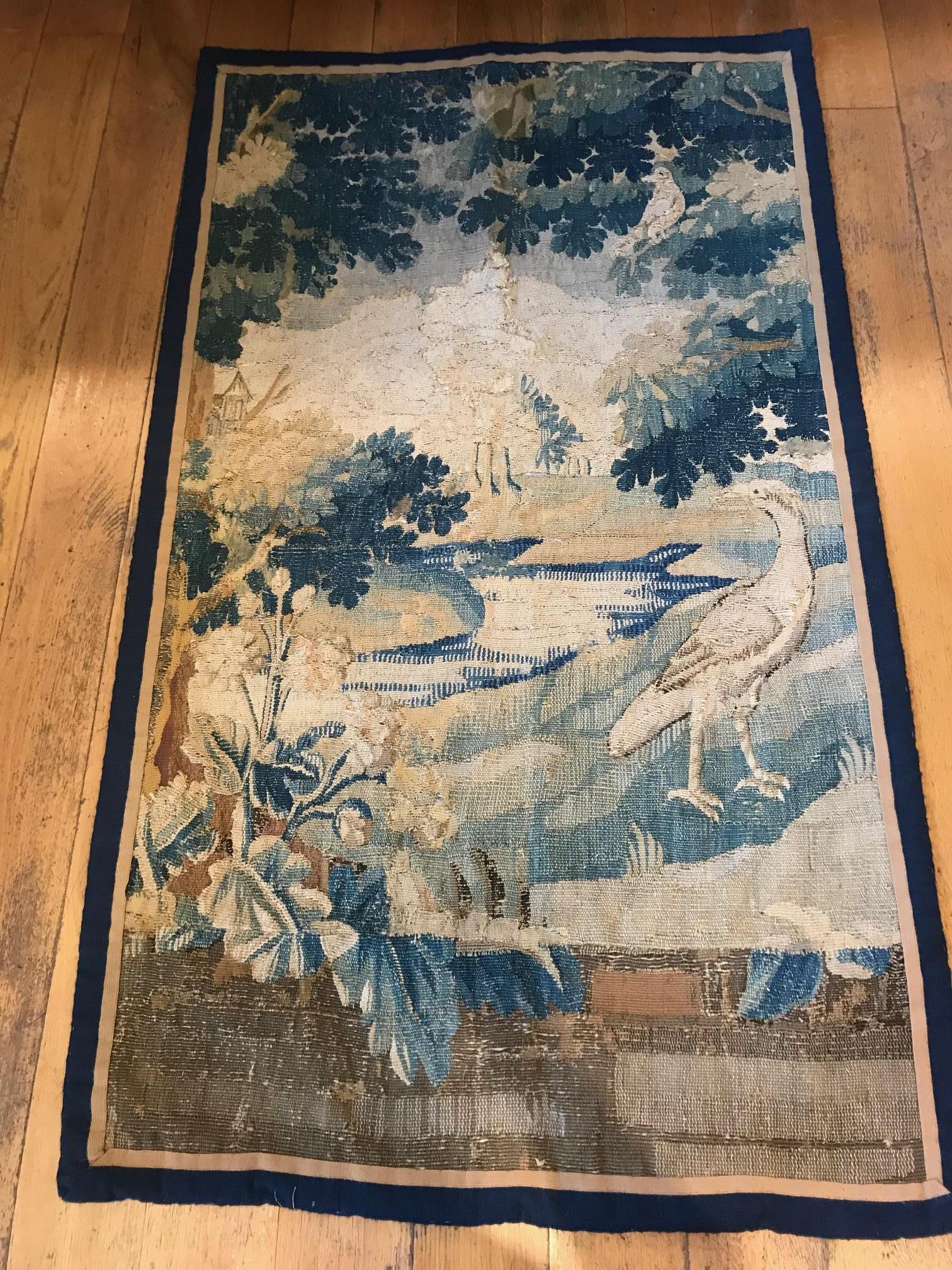 A decorative 18th century Aubusson wall hanging or tapestry. Handwoven depicting verdure and birds. Has been relined and restored at some point, though in need or re-looming in certain spots where the previous restorations have come loose or where