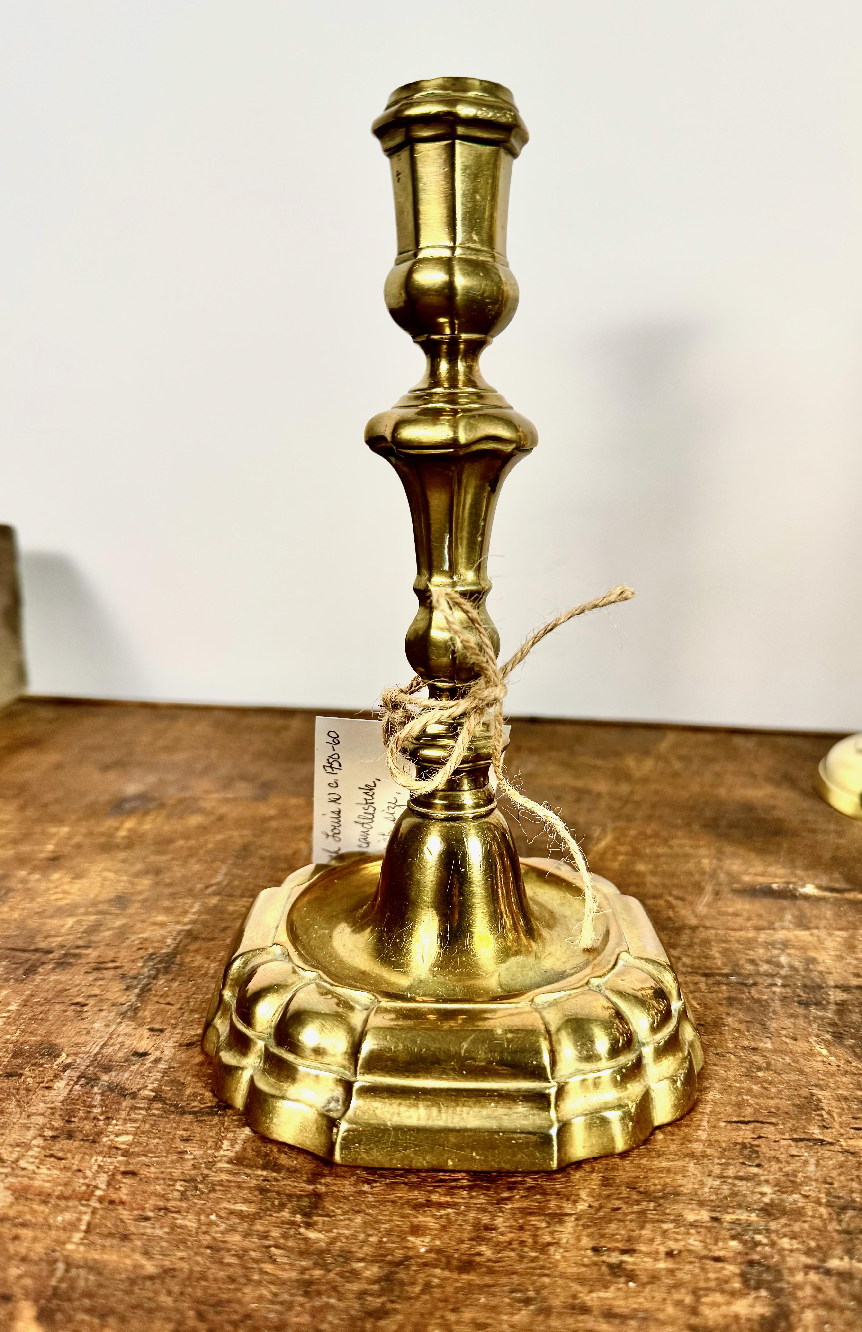 This is a great example of a French period Baroque brass candlestick. The candlestick is in very good original condition. There is a slight dent to the round base of the stick and the nozzle is a tiny bit off plumb--but the candlestick remains