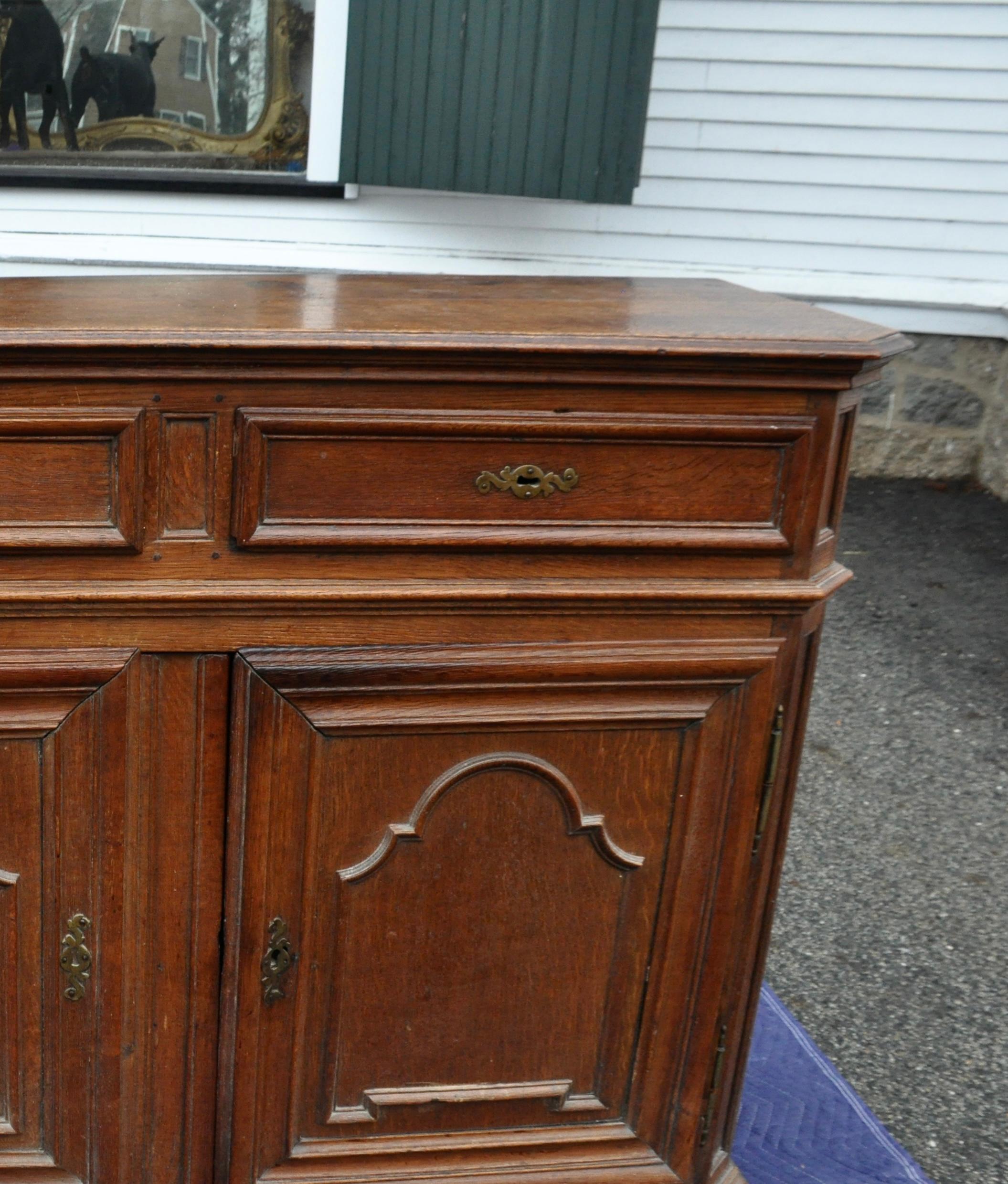 Period late 17th / early 18th century French oak credenza cabinet. Paneled cupboard doors with drawers above. Original hinges and hardware. Original feet

Provenance: Private Greenwich Collection from Gary Sergeant Antiques