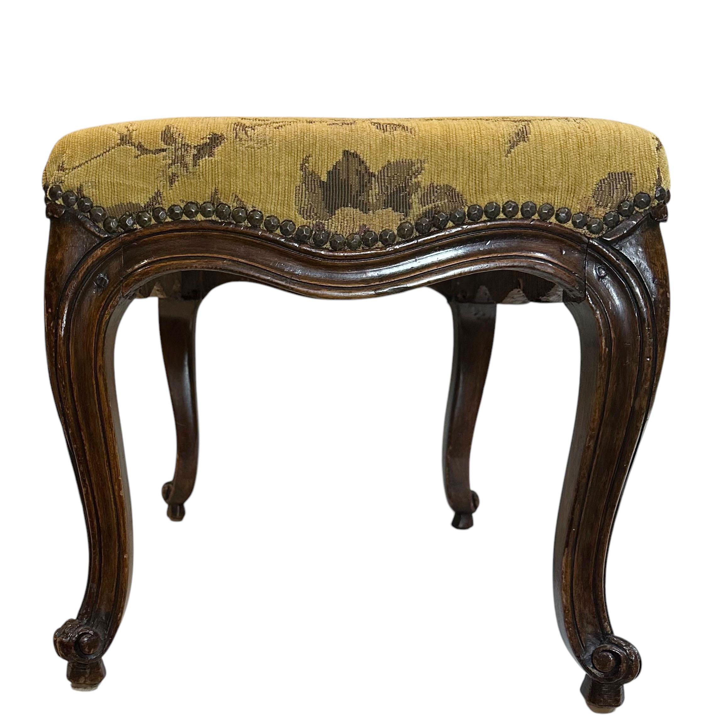 An 18th century walnut bench with a wonderful patina and  in very good condition for its age, nicely upholstered in Hendon fabric with has nail heads in an antique color. Circa 1770, France.