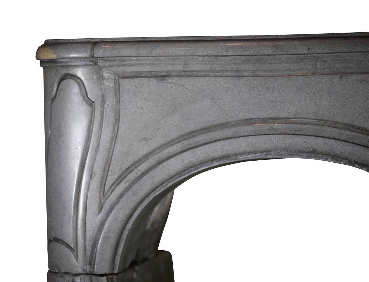 This 18th century fireplace surround was built in the Louis XIV period; it is one of two mantels. Both mantels are approximately same. There is only a small difference in the proportions of the two. Both mantles have rounded corners. The mantel