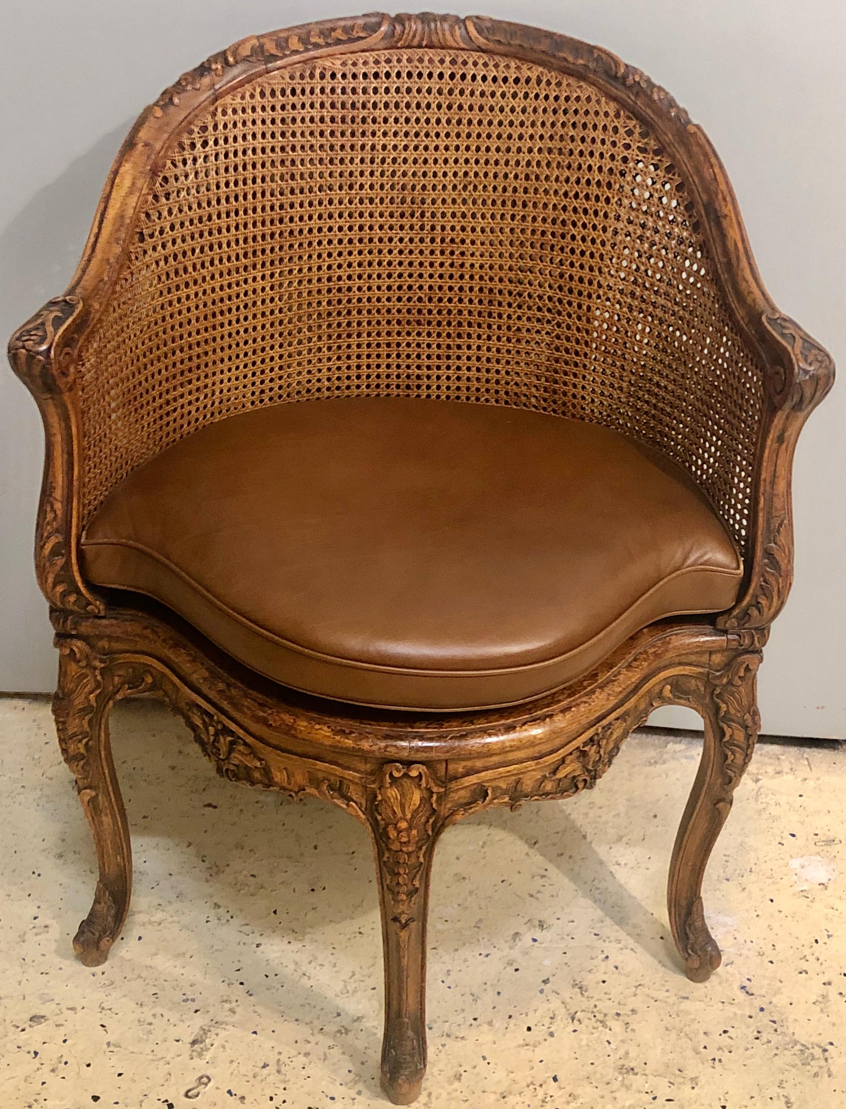 18th century French caned bergère de Bureau. A Louie XV beechwood bergère de Bureau with leather squab cushion, circa 1740. Magnificently carved. One of two presently available.

Please see: 
Sale #18793
The Collector: Property from Four