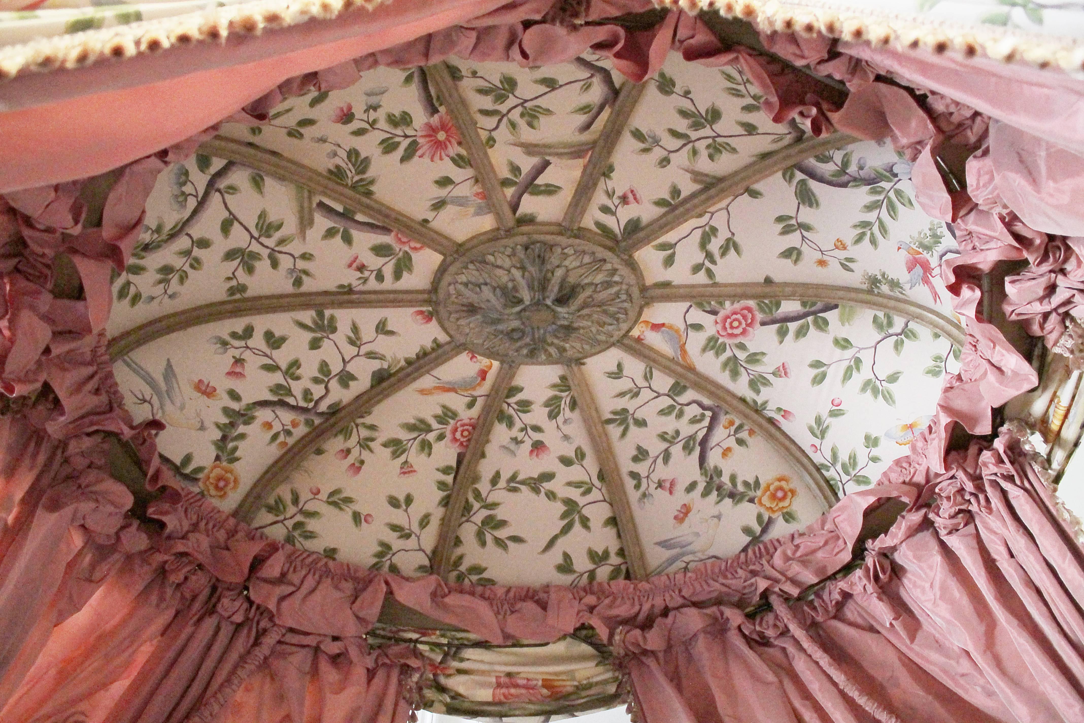 18th century French canopy daybed with toile upholstery
European canopy bed hand carved in the Louis XVI style upholstered in an asian toile
Background color is cream with hues of reds, pinks, greens and gold. Inside of the curtains are a pink