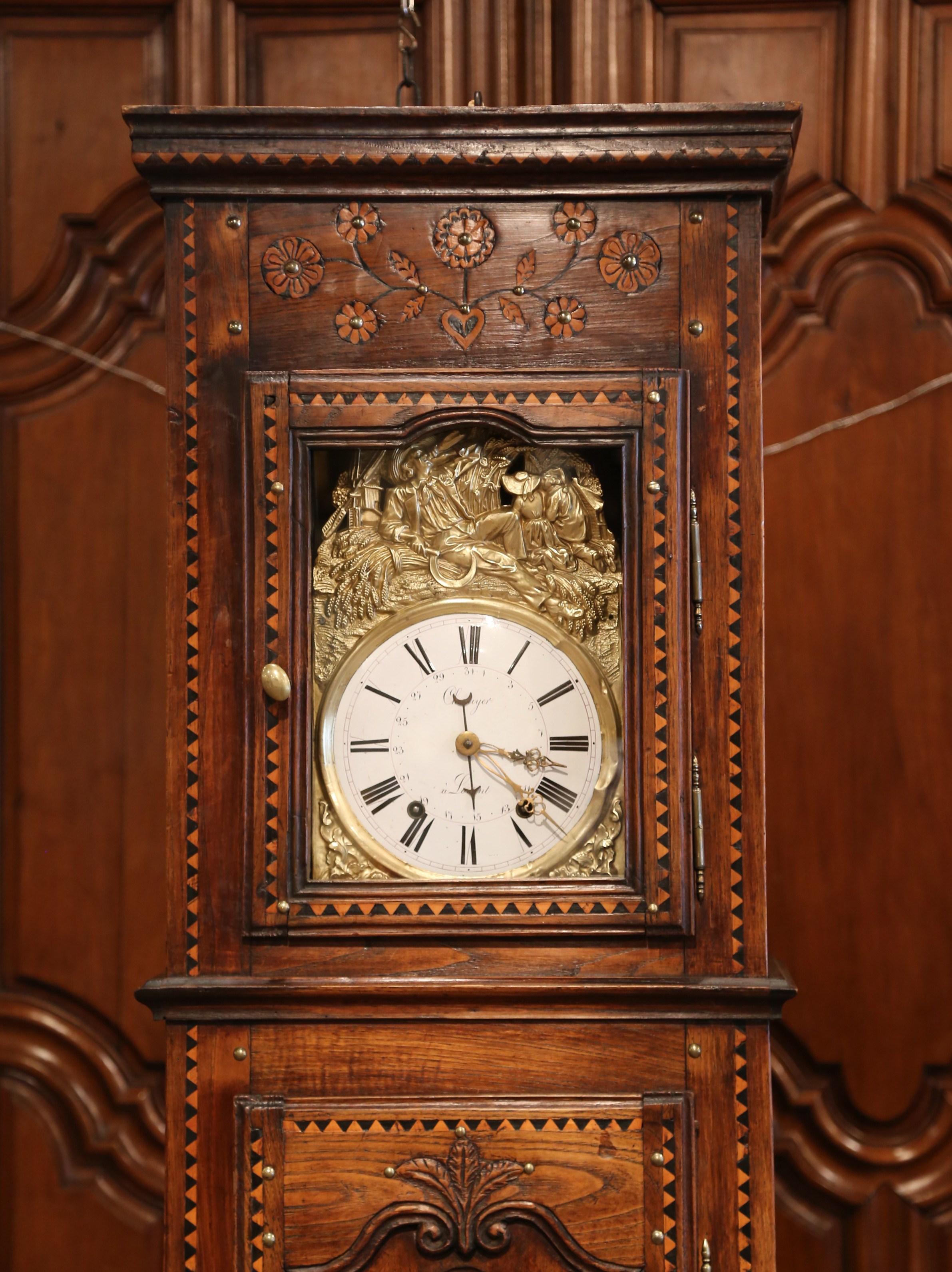 Bring additional life to a breakfast room with this antique long case clock. Crafted in Lorient (the west coast of Brittany), France circa 1780, this fruit wood clock features inlay floral and leaf decor on the facade. The timepiece is further