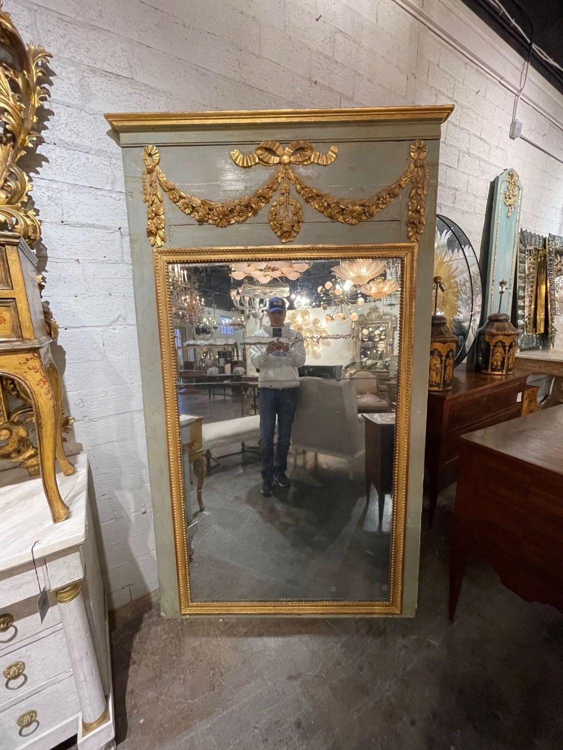 Fabulous 18th century French carved and parcel gilt Trumeau mirror. Featuring a beautiful carvings and patina. The piece also has a divided mirror with original mercury glass. Simply gorgeous!!