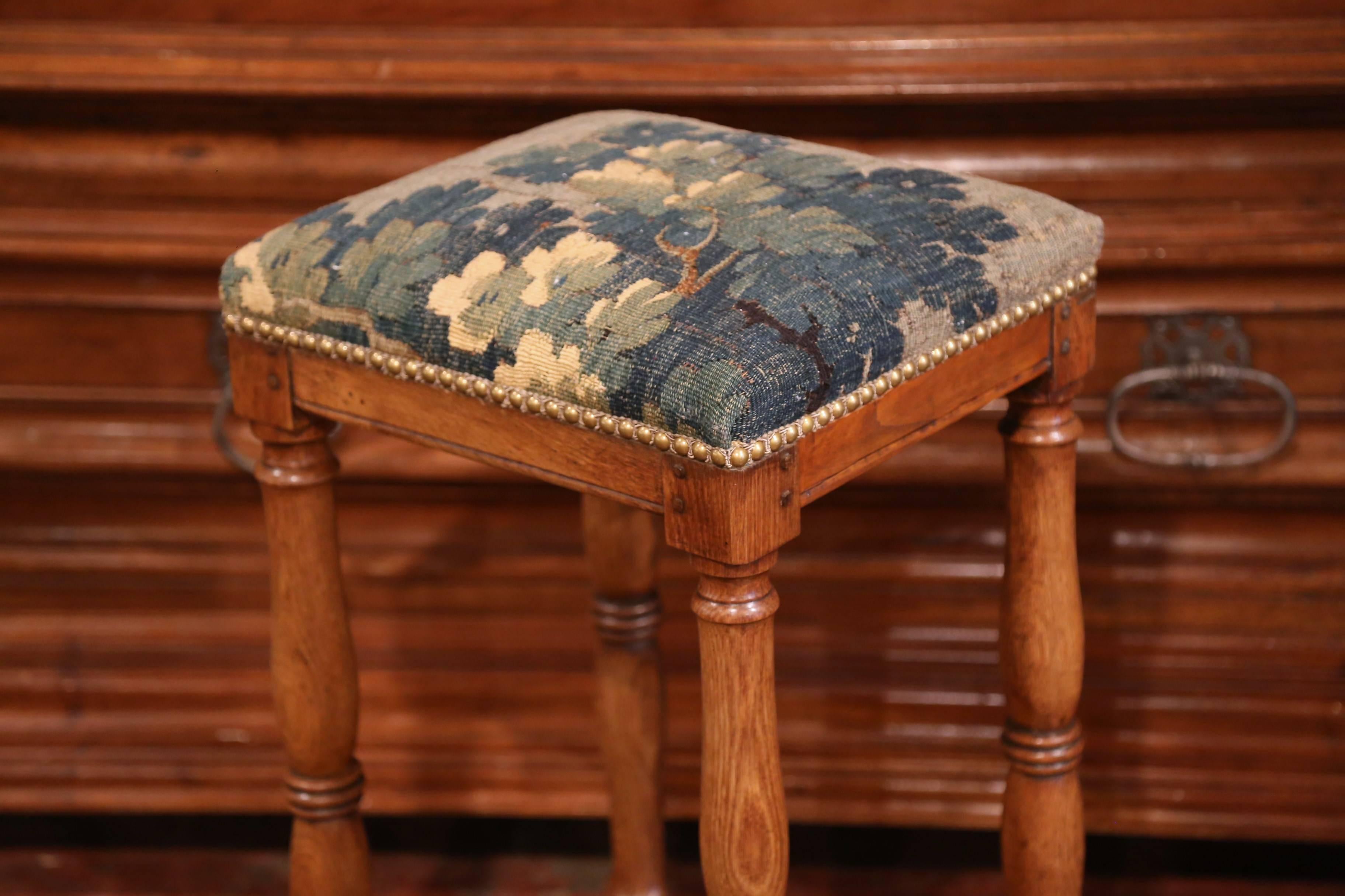 This antique fruitwood Prie-Dieu (or prayer chair), was crafted in France, circa 1790; the bench features four nicely carved turned legs with a bottom stretcher and a platform to rest your knees. The armrest has a verdure Aubusson tapestry with