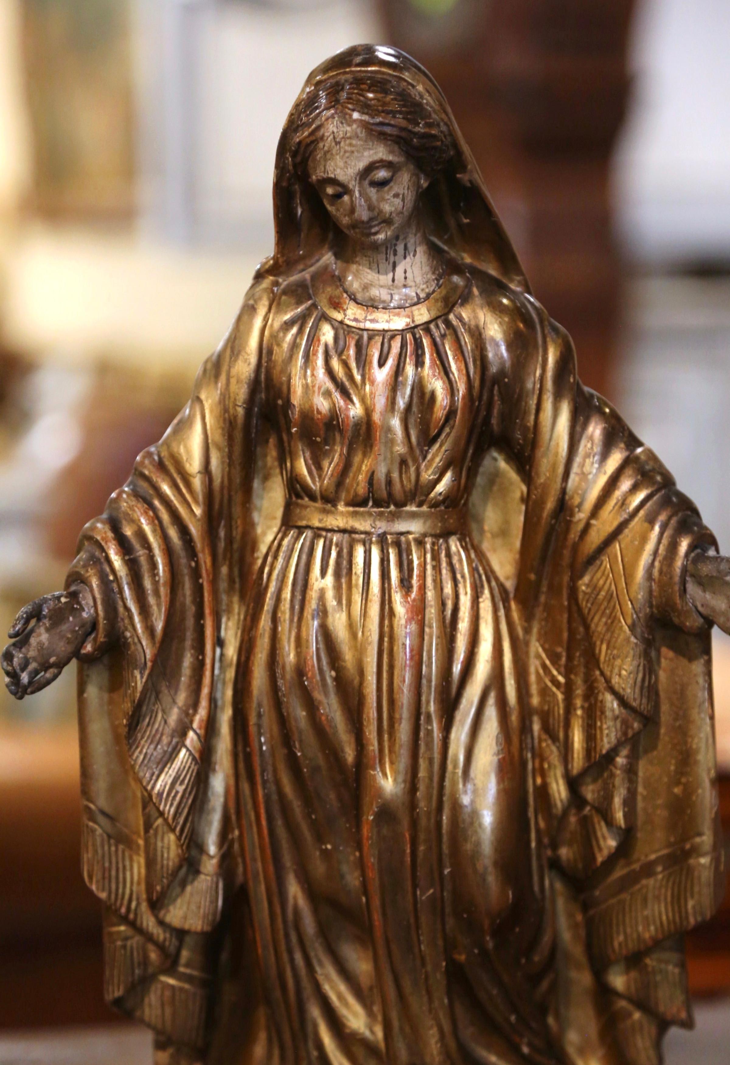 This beautiful, antique sculpture of the Virgin Mary in prayers was created in Provence, France, circa 1780. Embellished with gold leaf and polychrome finish, the classic religious figure is beautifully ornate and has wonderful details throughout