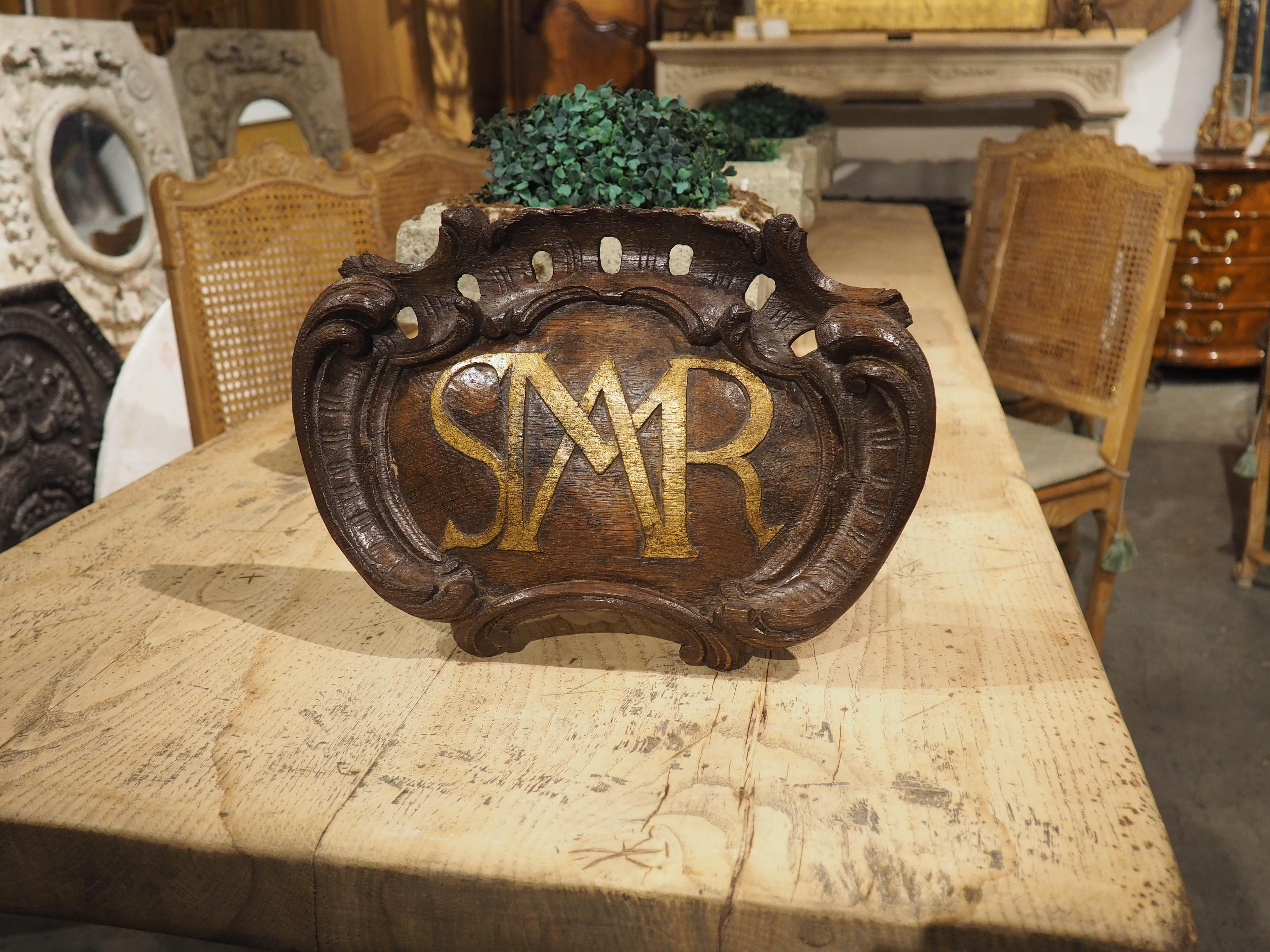 Hand-carved in oak and dating to the 1700s, this French altar plaque features a painted monogram that reads “AMSR”. The slightly raised carved initials (which stands for Ave Maria Salve Regina, which translates to “Hail Mary Hail Queen”) have been