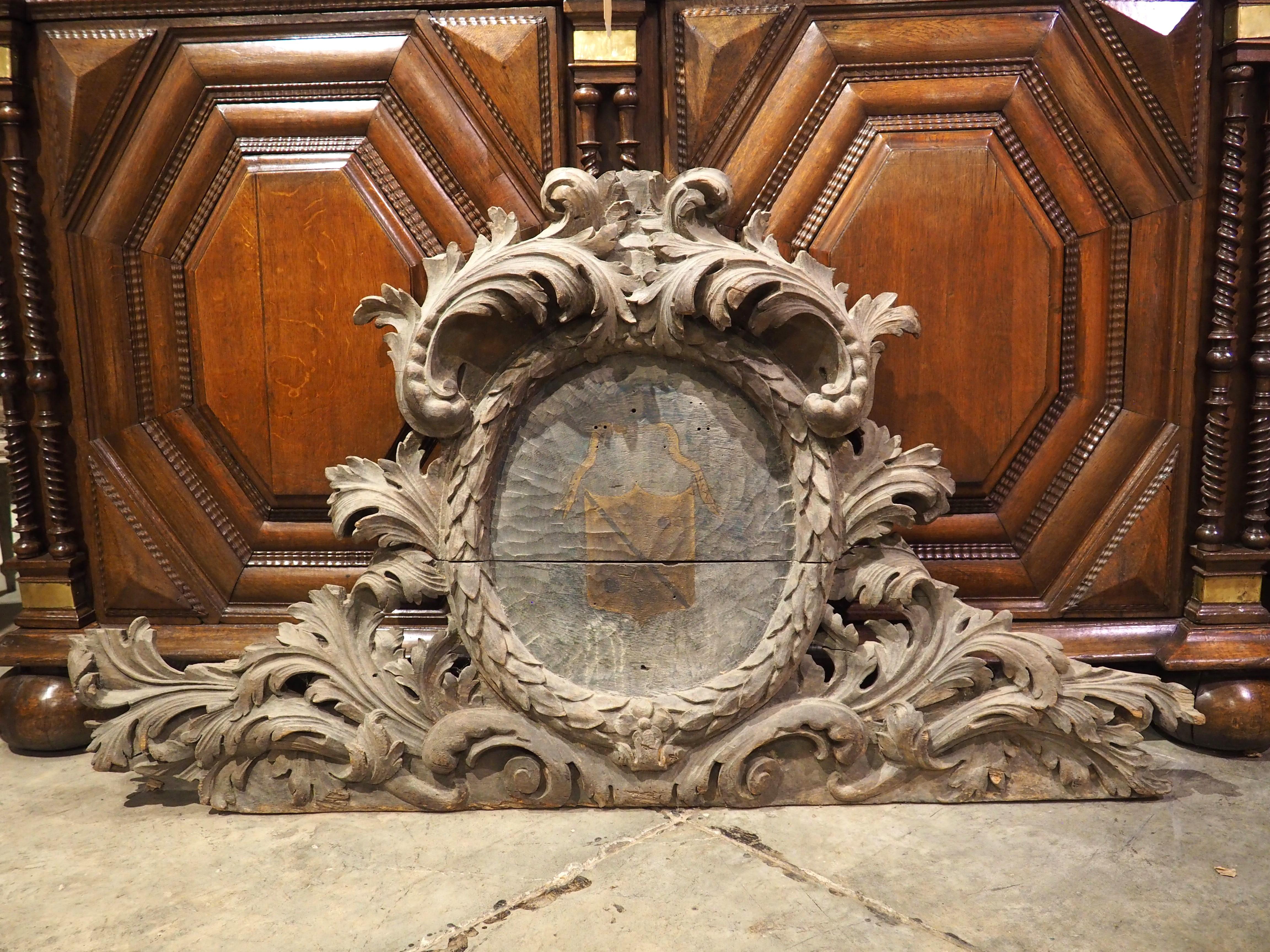 More information coming soon…

A well-carved chateau overdoor, this French architectural dates to the 1700s.  The oak wood has been wonderfully carved, forming a thick foliate surround to a painted coat of arms center.