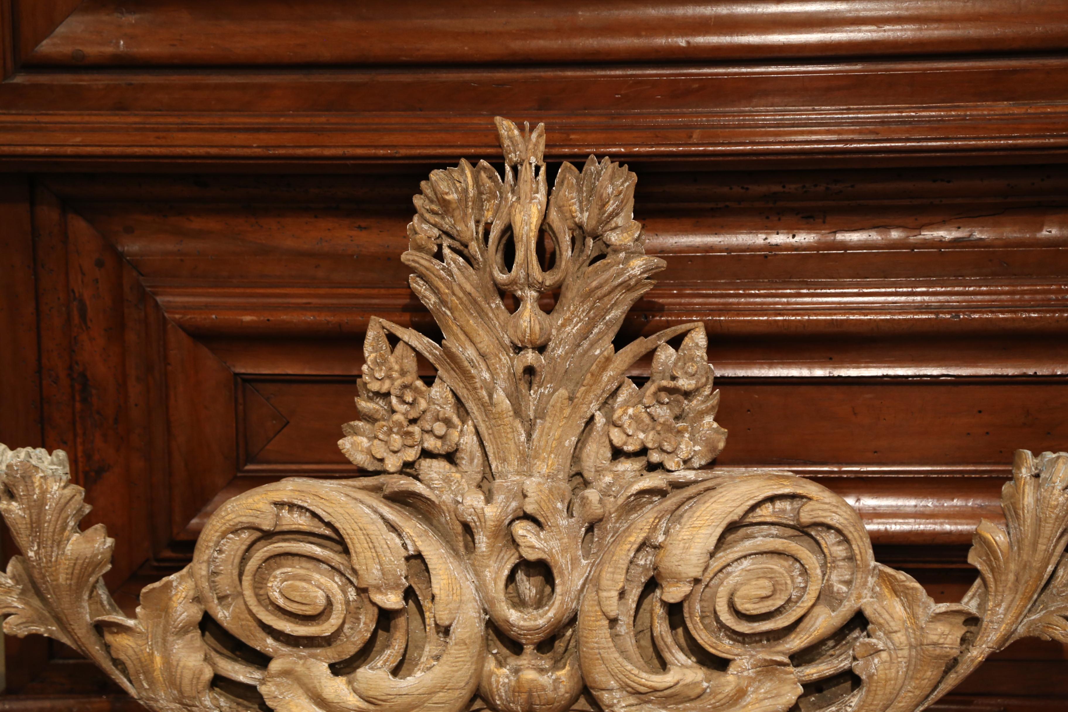 Place this important antique wood carving over a mantel; hand-carved in Normandy, France, circa 1780, the large Louis XV wall hanging sculpture features a large shell motif at the bottom flanked by scroll foliage and floral and leaf motifs on both