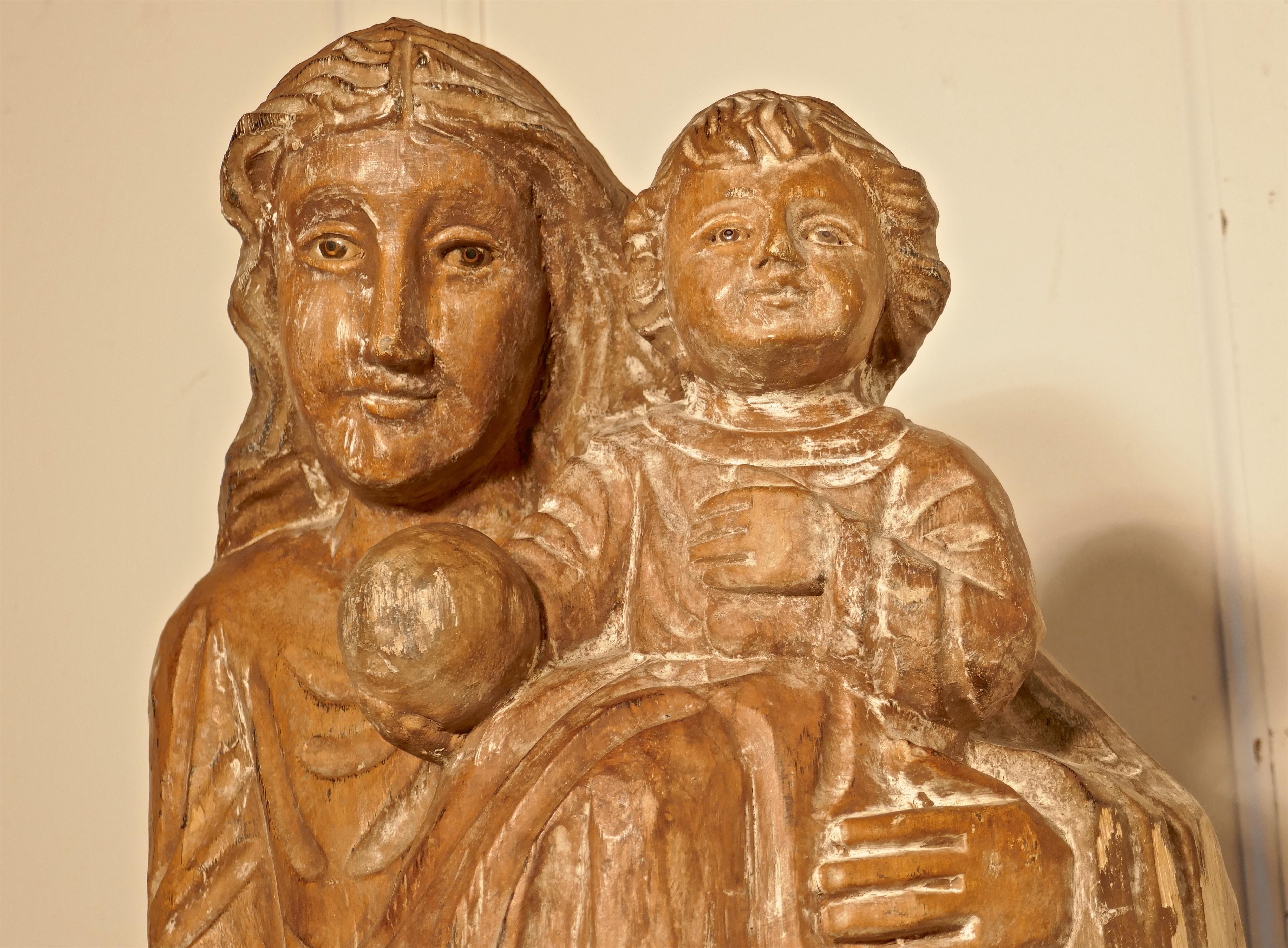 18th century French carved statue of Madonna and Child.

This charming piece has been rescued from a ecclesiastic clear out in the southern part of France
The statue is carved from one piece of hard wood, it shows the smiling Madonna holding the
